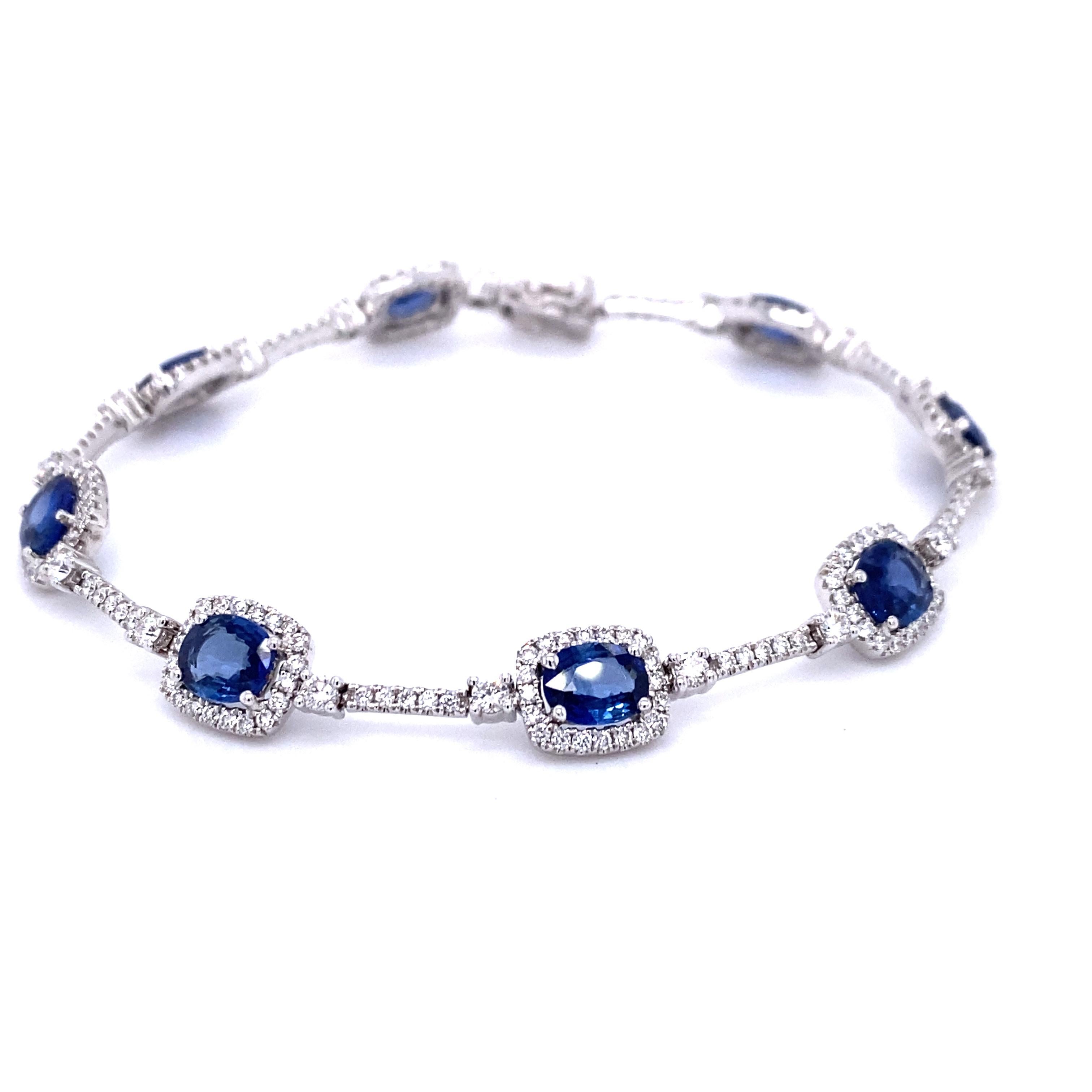 18ct white gold sapphire and diamond bracelet. Featuring 8 rectangular cushion cut sapphires that have a combined weight of 5.55ct and measure 6mm long by 4mm wide. Each sapphire is surrounded by a halo of micro claw set round brilliant cut