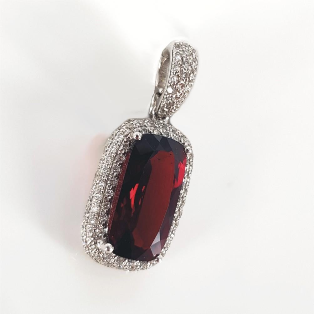 This Gorgeous 18ct White Gold Pendant weighs 3grams and is carefully set with 107 beautiful Round Brilliant Cut Diamonds (GH vs-si) weighing 0.54carat in total and 1 Cushion Cut Garnet measuring 21mm x 9mm. 