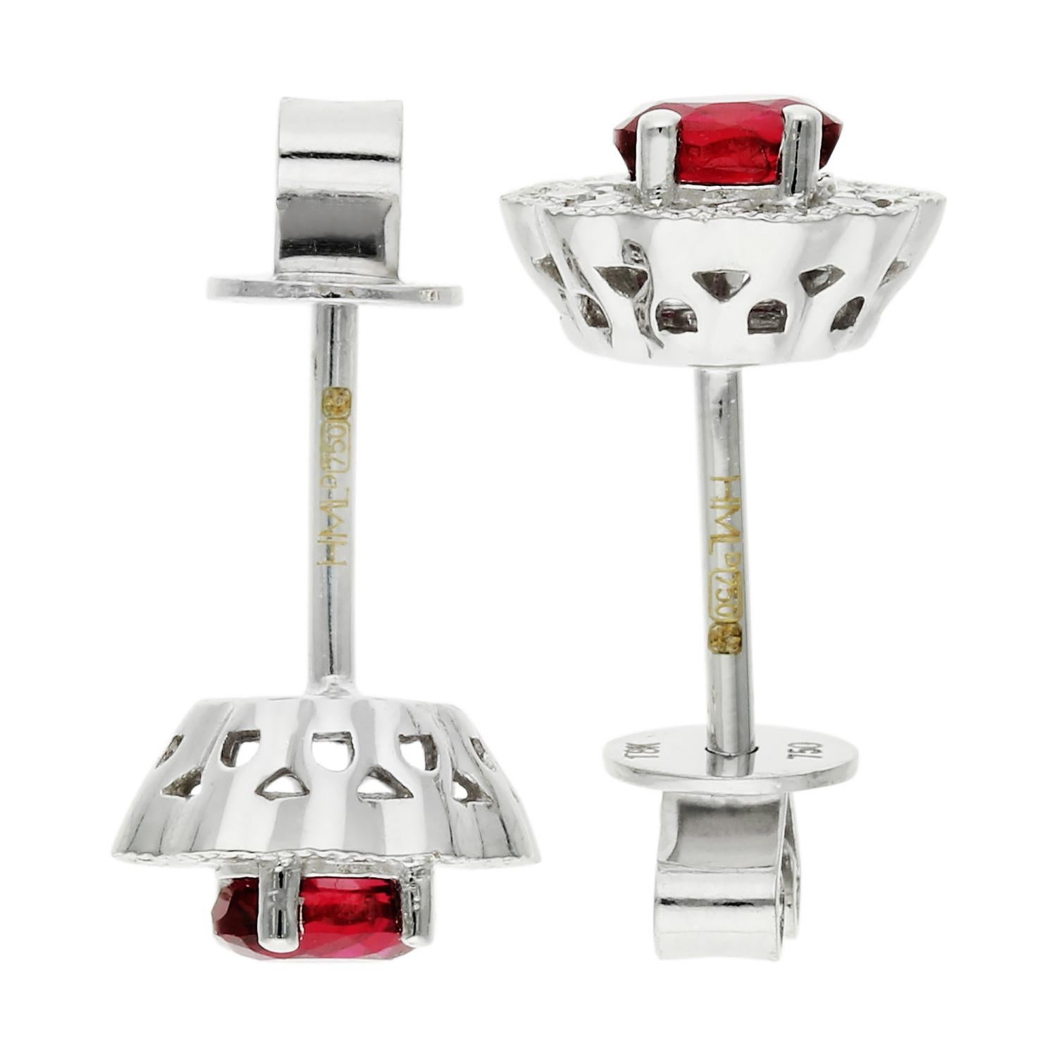 18ct White Gold Diamond & 0.44ct Ruby Earrings

Discover the timeless allure of our 18ct White Gold Diamond & 0.44ct Ruby Earrings. Each earring showcases an oval-cut ruby, deep in colour and totalling 0.44ct, encased in a frame of shimmering claw