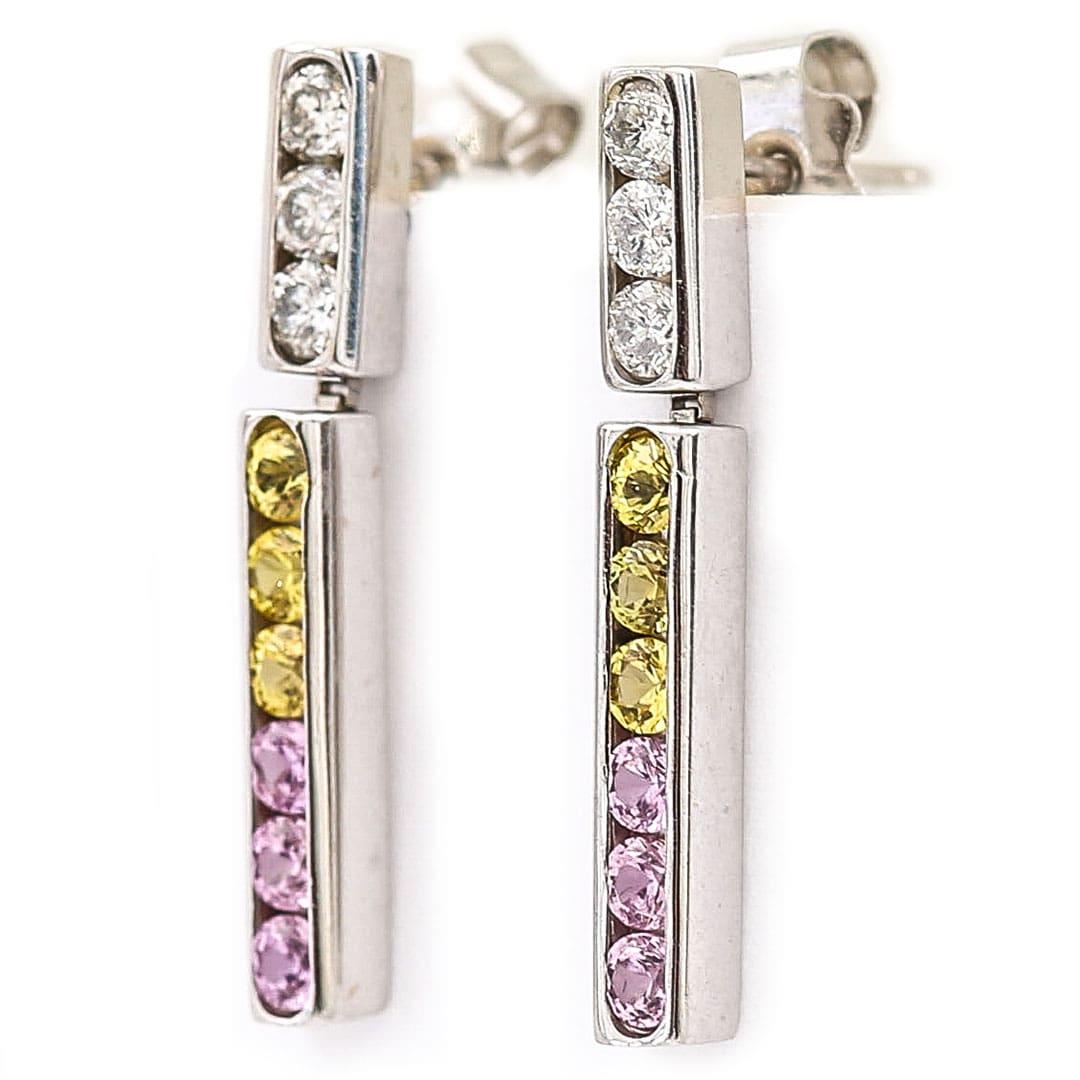 A very pretty pair of 18ct white gold diamond and multi coloured sapphire drop earrings, comprising of diamonds with yellow and pink sapphires in a channel setting. Estimated total weight of the diamonds is 0.20ct. 

They have a very pleasing