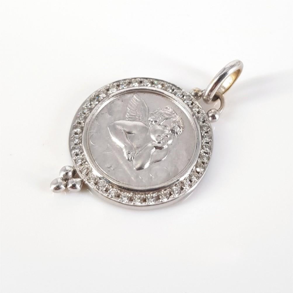 This Gorgeous 18 carat white gold Cherub pendant is carefully set with 34 round brilliant cut diamonds weighing 0.51 carat in total of HI/vs-si quality. This Pendant is 20mm in diameter and weighs 7.3 grams.