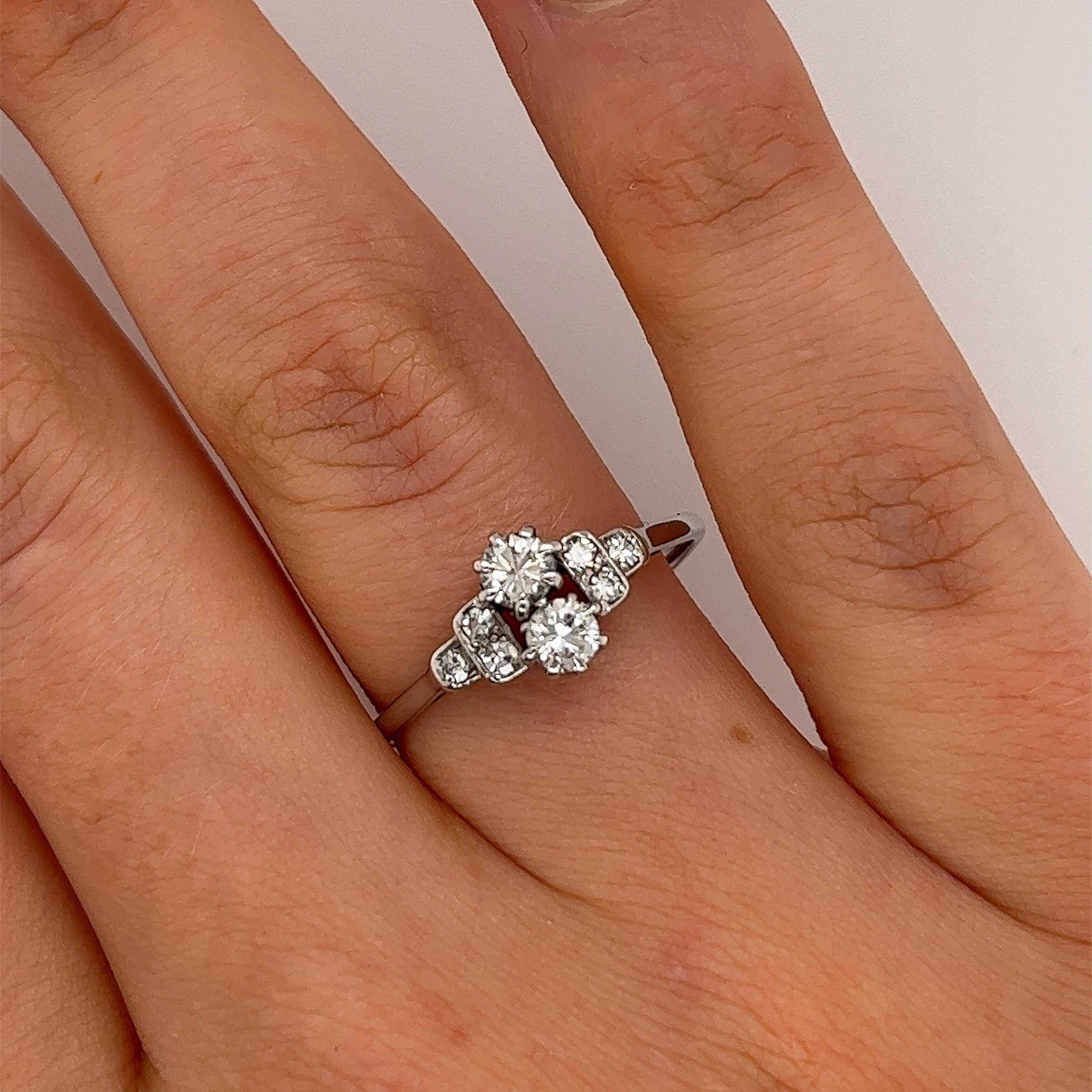 Elegance and sophistication, this preloved 18ct white gold diamond ring set with 2 brilliant cut vertically set central diamonds each of 0.20ct each, franked each side by 3 small diamonds.

Total Diamond Weight: 0.50ct
Diamond Colour: G/H
Diamond