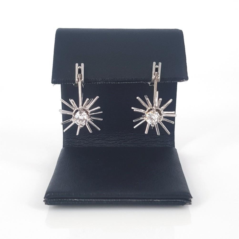 These unique pair of drop earrings are set in 18Carat White Gold, featuring main center round brilliant cut diamonds with a carat weight of 0.32 each. These earrings weigh 5.8 grams and the diamonds are F in Colour and vvsi in clarity.