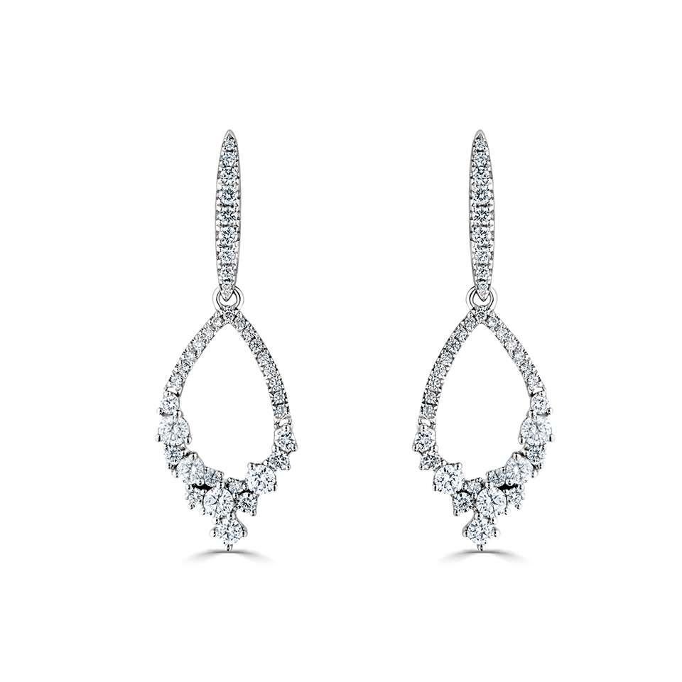 18ct White Gold 1.00ct Diamond Drop Earrings 

Discover the enchanting allure of our 18ct White Gold Diamond Drop Earrings, a masterpiece of design that captures the essence of natural elegance. These exquisite earrings feature stylised leaf-shaped