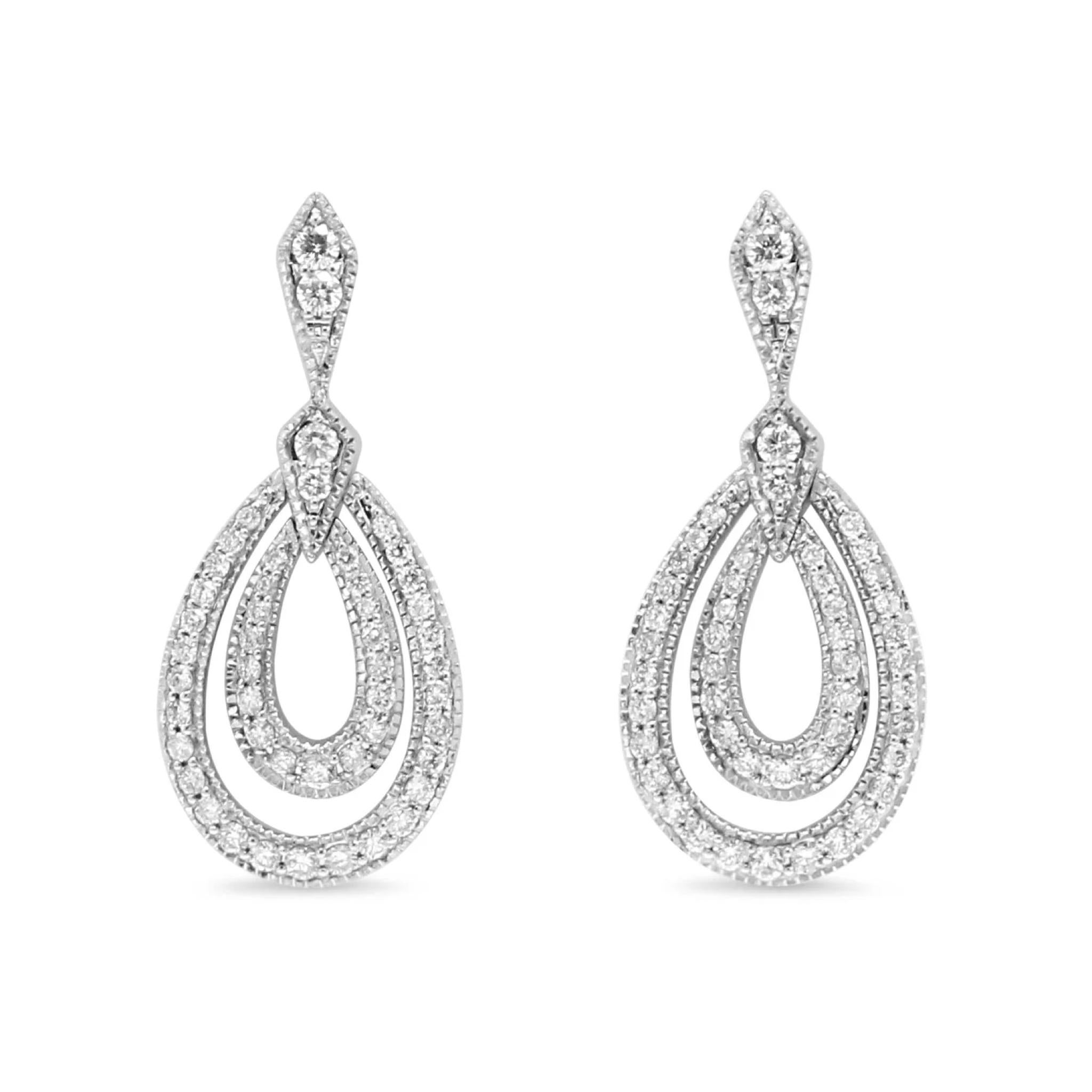 Elevate your style with these brand new 18ct White Gold Diamond Drop Earrings.  Crafted from the finest materials, adorned with a generous 0.80ct total of Diamonds, these unworn earrings will add a subtle delicacy to your earring collection and