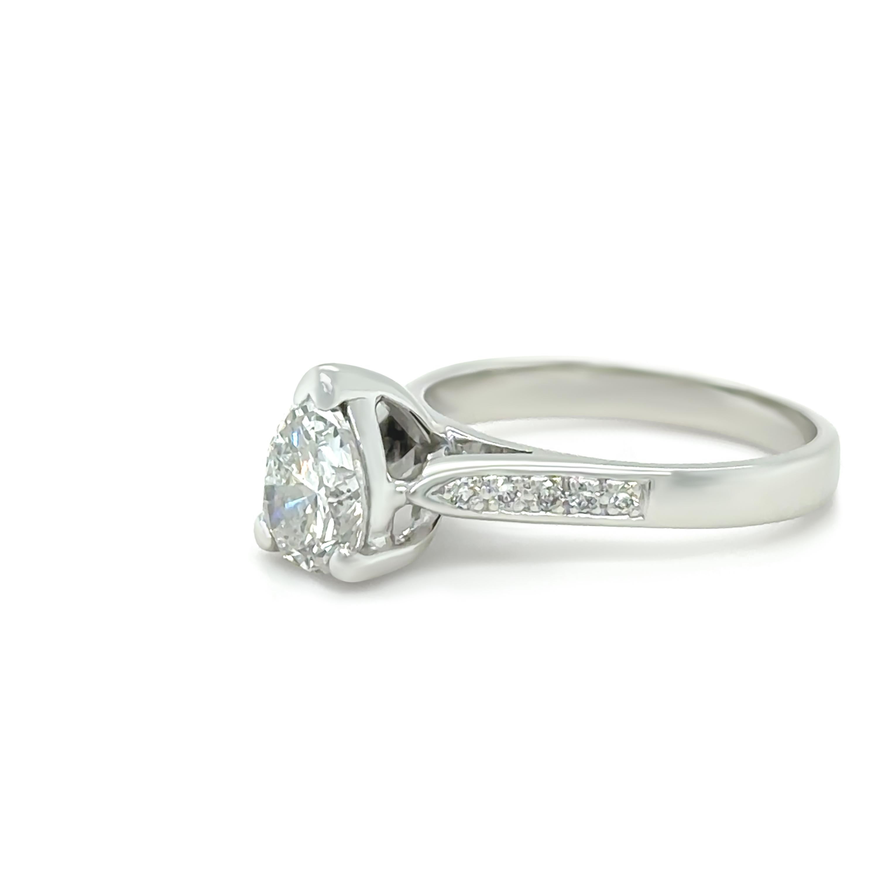 This custom-made diamond engagement ring exudes timeless elegance, crafted in 18ct white gold. It features a breathtaking pear-shaped, brilliant-cut diamond weighing 1.15 carats, with a colour grade of F and clarity grade of I1, securely set to draw