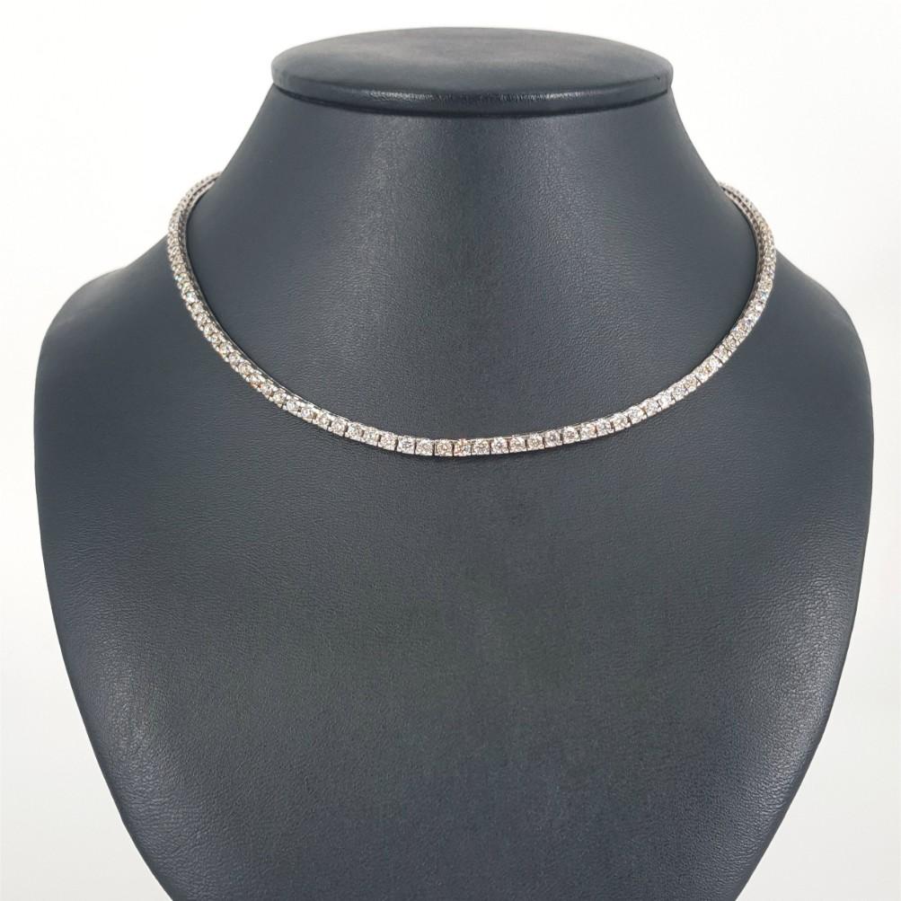 This Diamond Tennis Necklace is made in 18ct Yellow Gold featuring 130 RBC Diamonds weighing a total carat weight of 5.7 carat. Diamonds are JK in Colour and vs-si in Clarity. This Necklace weighs 32.1 grams and is 43.5cm in length. Clasp: Tongue in