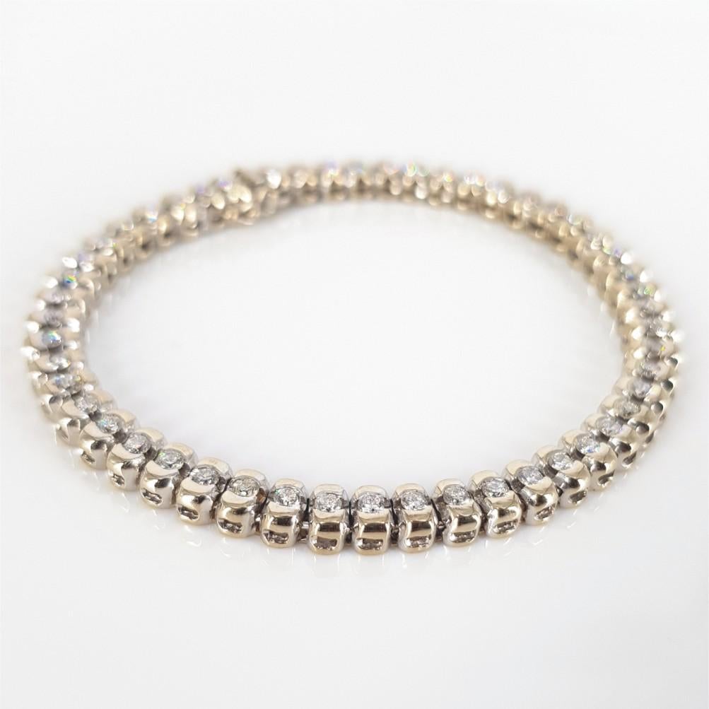 This Beautiful studded Tennis Bracelet is set in 18 carat White Gold, weighs 20 grams and measures 18.5cm in length, 4mm wide and 3.5mm in height. This Bracelet features 51 Round Brilliant Cut Diamonds weighing 1.53carat in total Diamonds are of