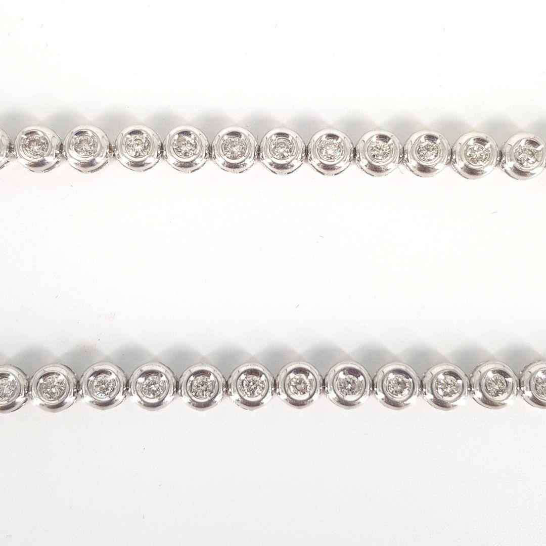 Elegant and dazzling.
Chain Attributes:
Metal Colour:		White Gold
Metal:			18CT
Length:                            	415mm
Width: 			0.5mm
Weight:			21.g 

Stone Attributes
Stones:              	Diamond
Number:		       78
Carat  			0.05p (Total