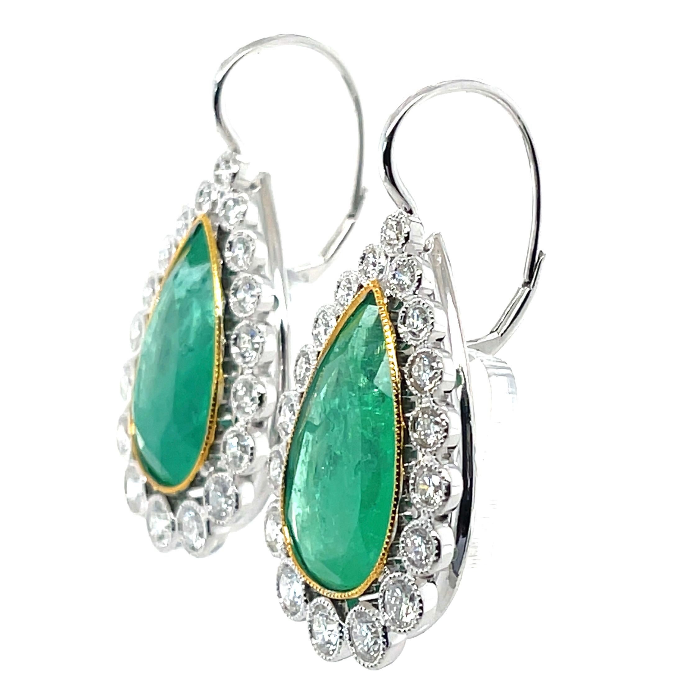 Pair of pear cut Colombian (based on my opinion) emerald, crafted with eighteen karat yellow gold, featuring a beautiful selection of thirty-six bezel set round brilliant cut diamonds, complimented by a beautiful polished finished design.

Emerald