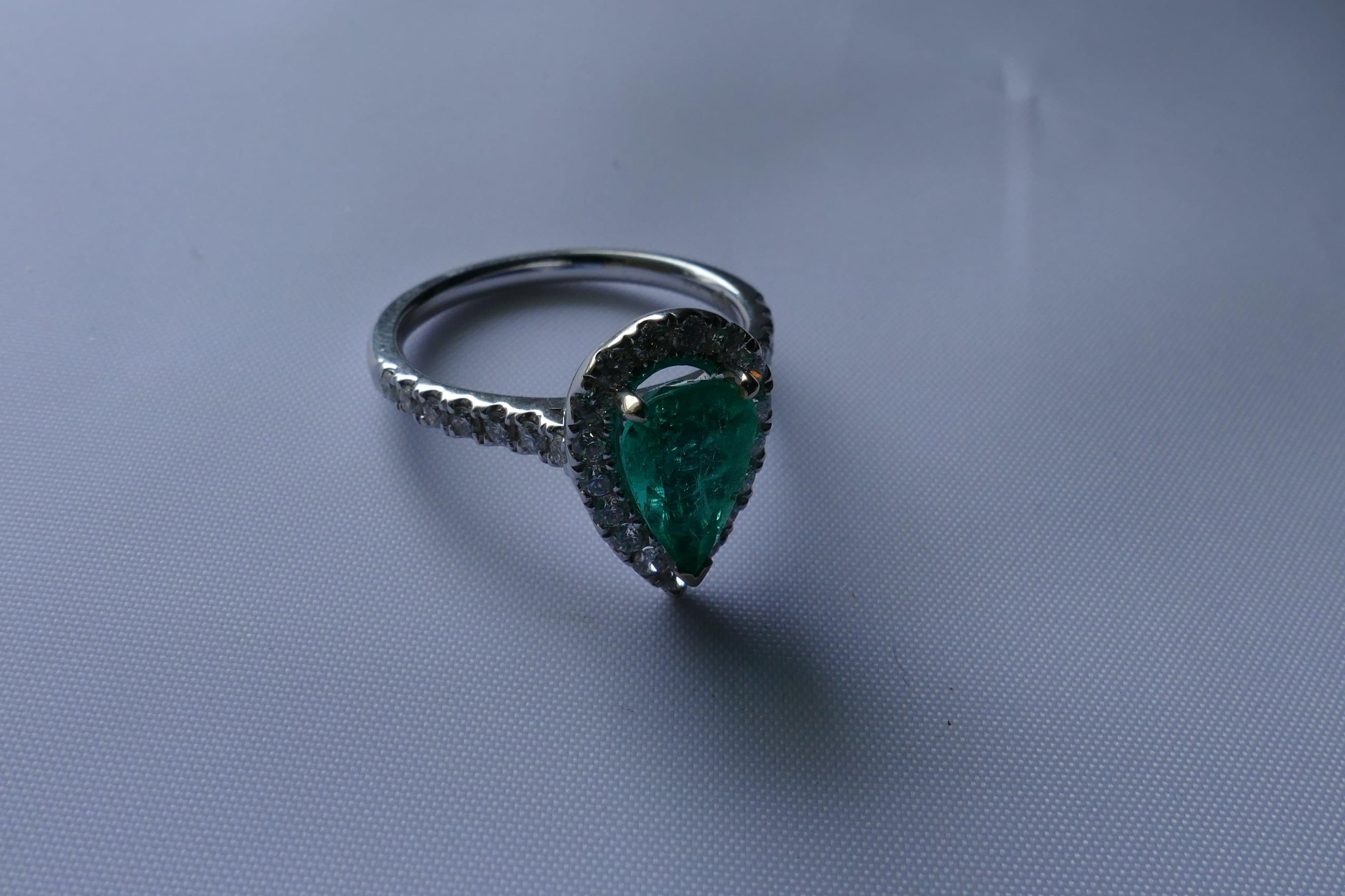This 18ct White Gold Pear Shaped high quality Emerald is surrounded by 31 equally high level Round Cut Brilliant Diamonds totalling over half a carat.
Absolutely beautiful  natural colour Emerald stone which weighs 1.5 Carats and looks stunning on