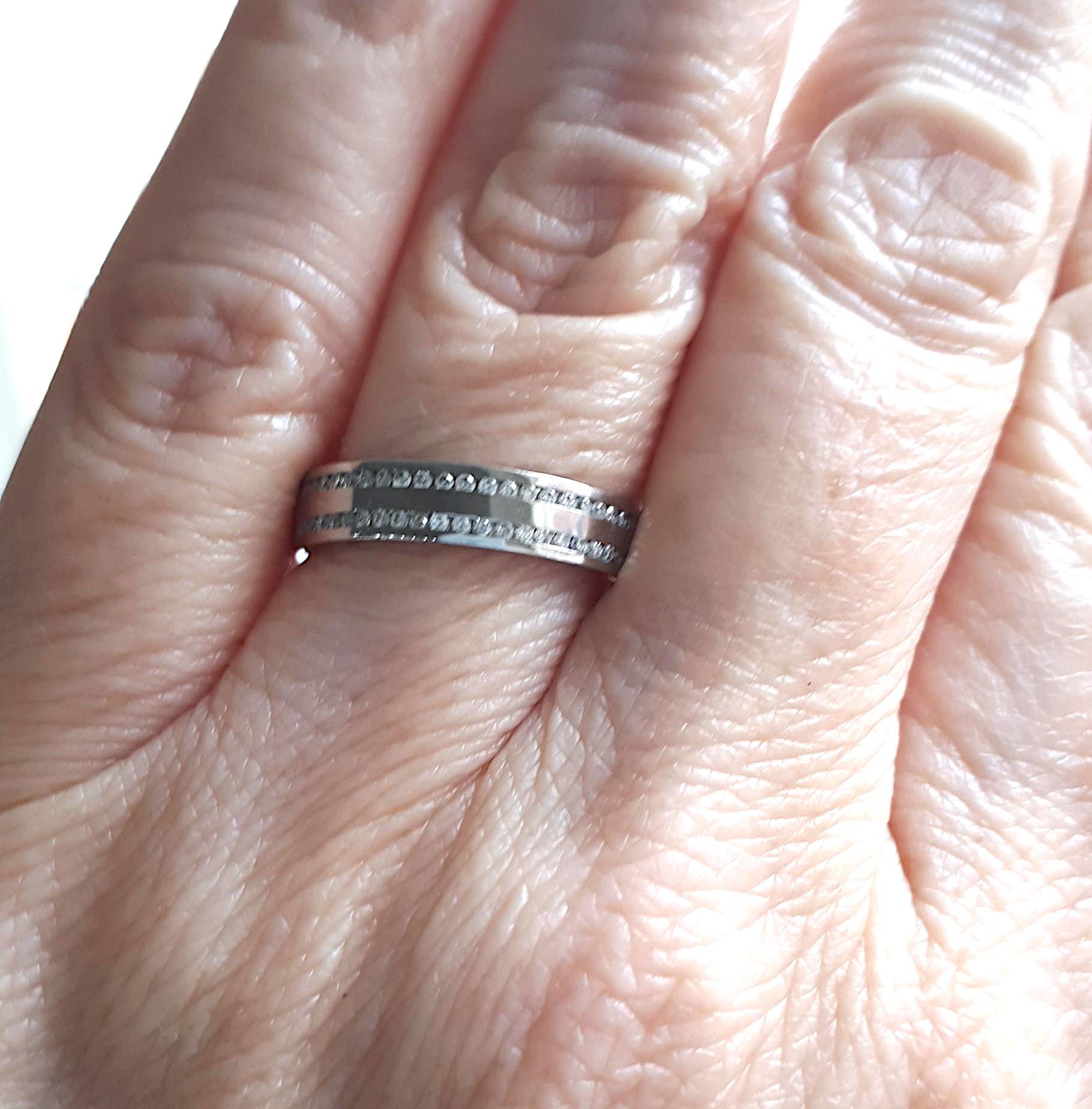 A modern eternity or wedding band, set with two continuous rows of round brilliant-cut diamonds, weighing an estimated total of 0.56 carats, mounted in 18ct white gold.