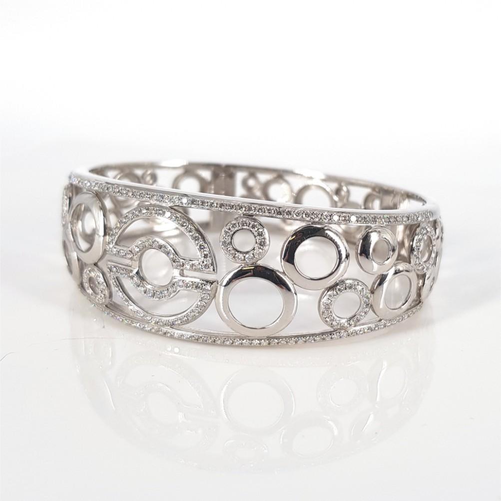 This Lovely Bangle is set in 18 carat White Gold, weighs 39.36grams, measures 62mm x 51mm. This Bangle features 330 RBC Diamonds (GH vs-si) weighing 4.95carat in total. Clasp: Clip Hinge