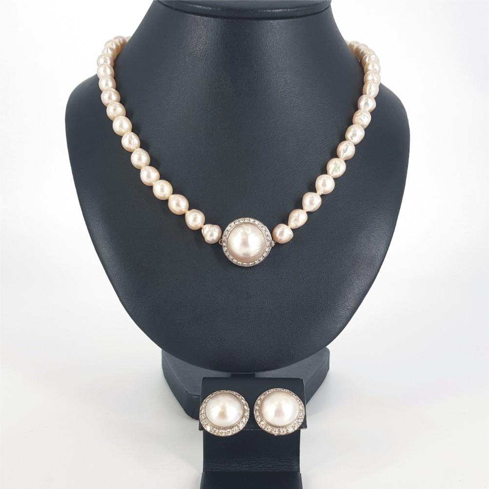 A vintage style Pearl & Diamond parure of jewellery, comprising a necklace, clip on earrings.
This stunning necklace and earrings set - using Mabe Pearls & White Diamond, are all set in 18K white gold.

Necklace Details: 	1 Mabe Pearl – 17mm 
      