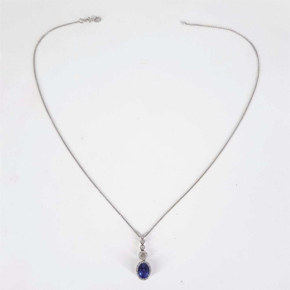 This sweetly designed necklace is 42cm in length and weighs 10grams. This necklace is set in 18carat White Gold featuring a pendant studded with 1 Oval Cut Tanzanite weighing a total of 1.17ct, 3 RBC Diamonds (GH vssi) weighing 0.02carat each and 23