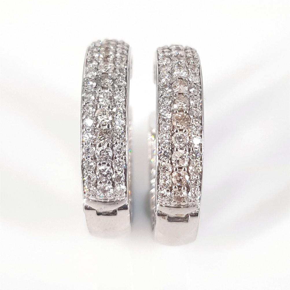 These earrings are stunning inside and out! Made is 18 Carat White Gold and weighing 11.9 grams, these hoops feature 160 RBC Diamonds weighing 0.15 carat each alongside 60 RBC Diamonds at the center, weighing 1.2 Carat in total. These hoops are 21mm