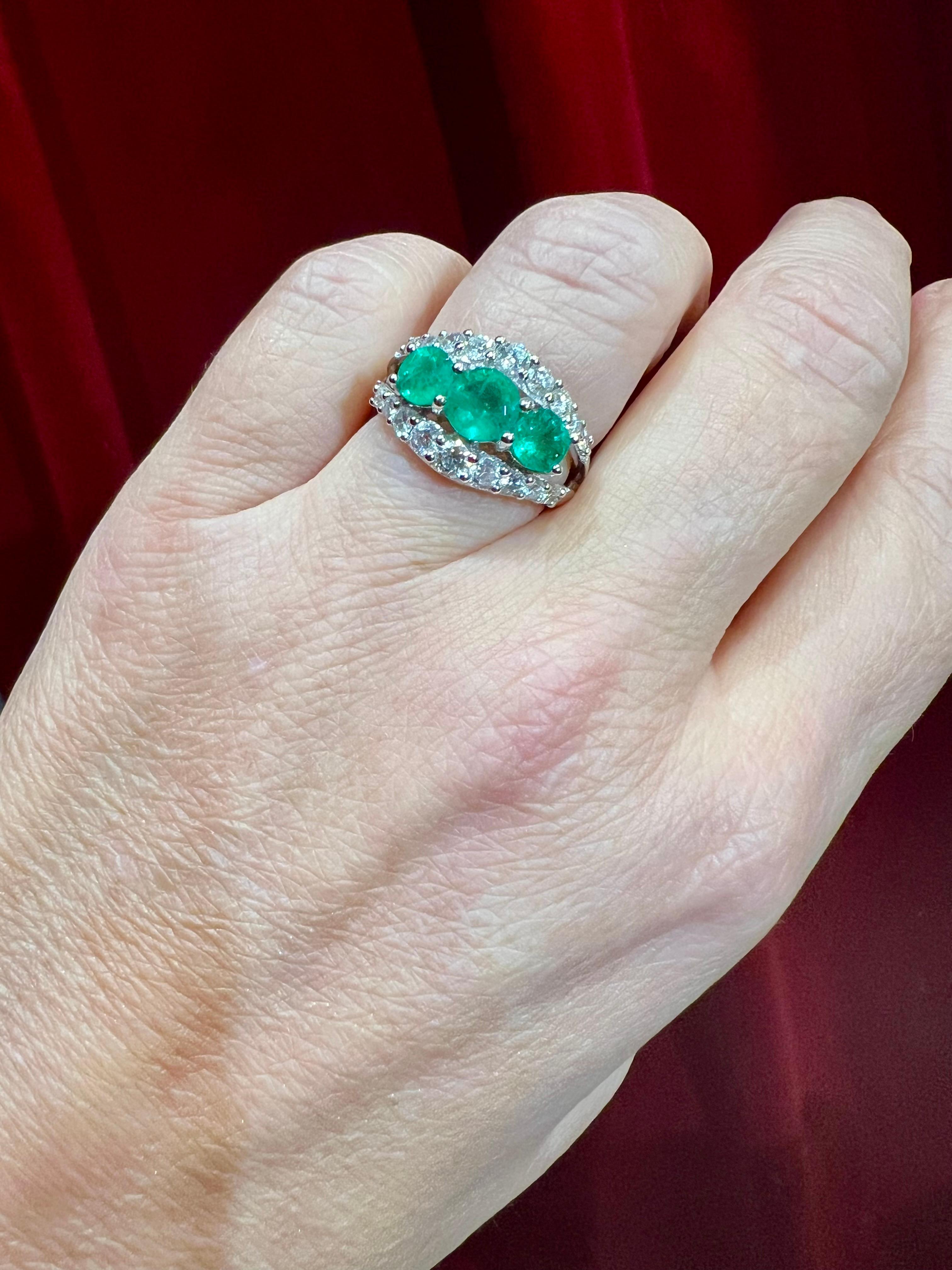 Ring in 18 ct white gold, model ¨forme jarretière¨
set with three emeralds weighing approximately 1.92 ct in total
surrounded by pavé-set brilliants for approx. 1 ct 
weight: 6.32 gr
size:54
proportion of the decorated part: 1.3cm at the widest part