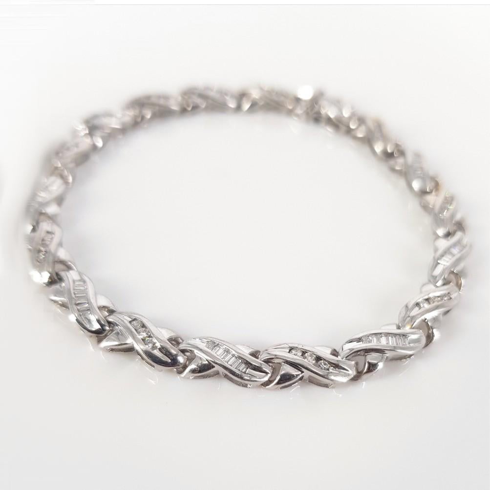 This Beautiful studded Bracelet is set in 18 carat White Gold, weighs 12.9 grams and measures 18cm in length, 5mm wide. This Bracelet features 27 Round Brilliant Cut Diamonds weighing 0.27 carat in total & 45 Baguette Cut Diamonds weighing 0.34carat