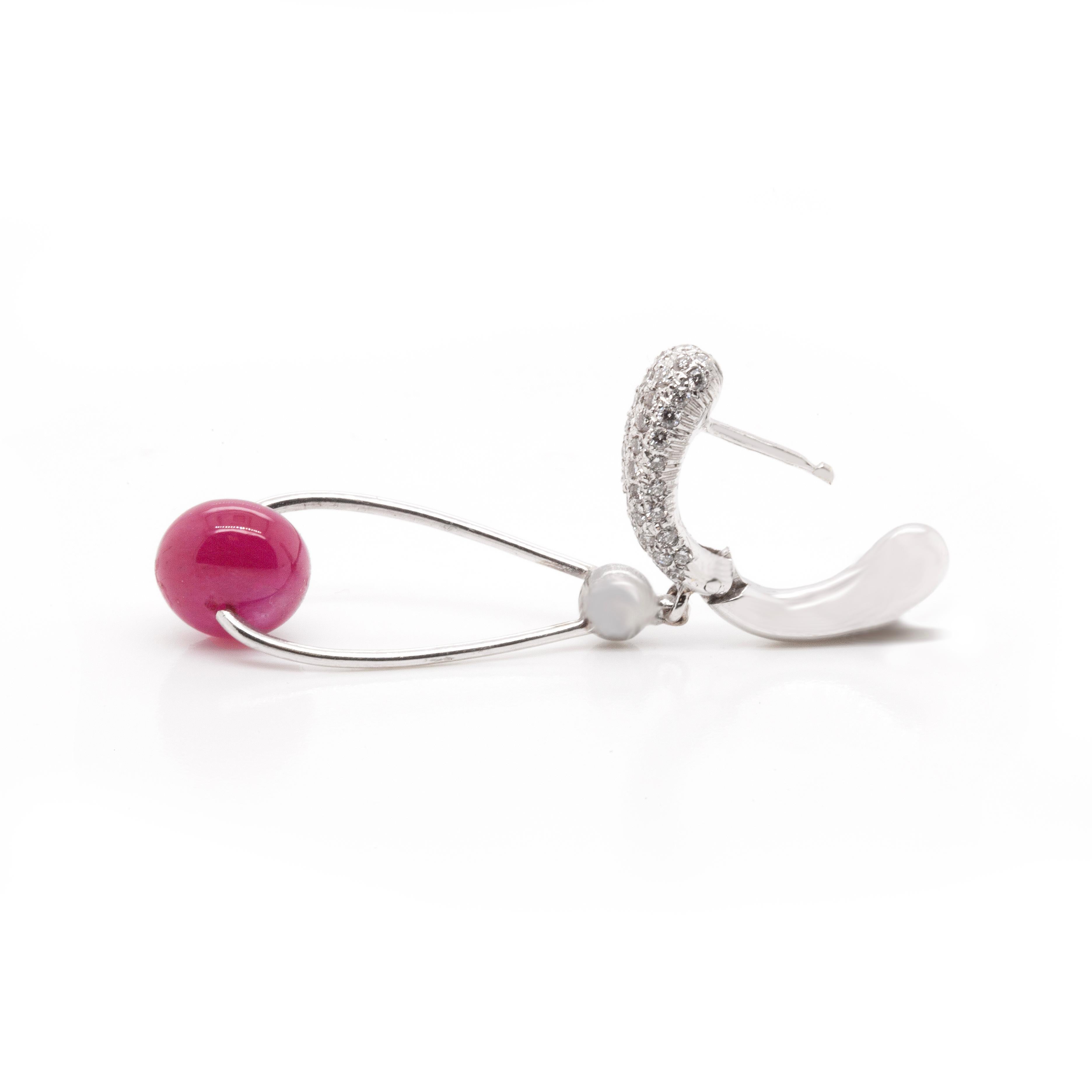 These beautiful ruby and diamond drop earrings are sublime. Fine quality diamonds are pavé set into the ear clips, which open with a hinge and secure easily by clicking into place at the back. 

A gorgeous 18ct white gold wire loop is simply