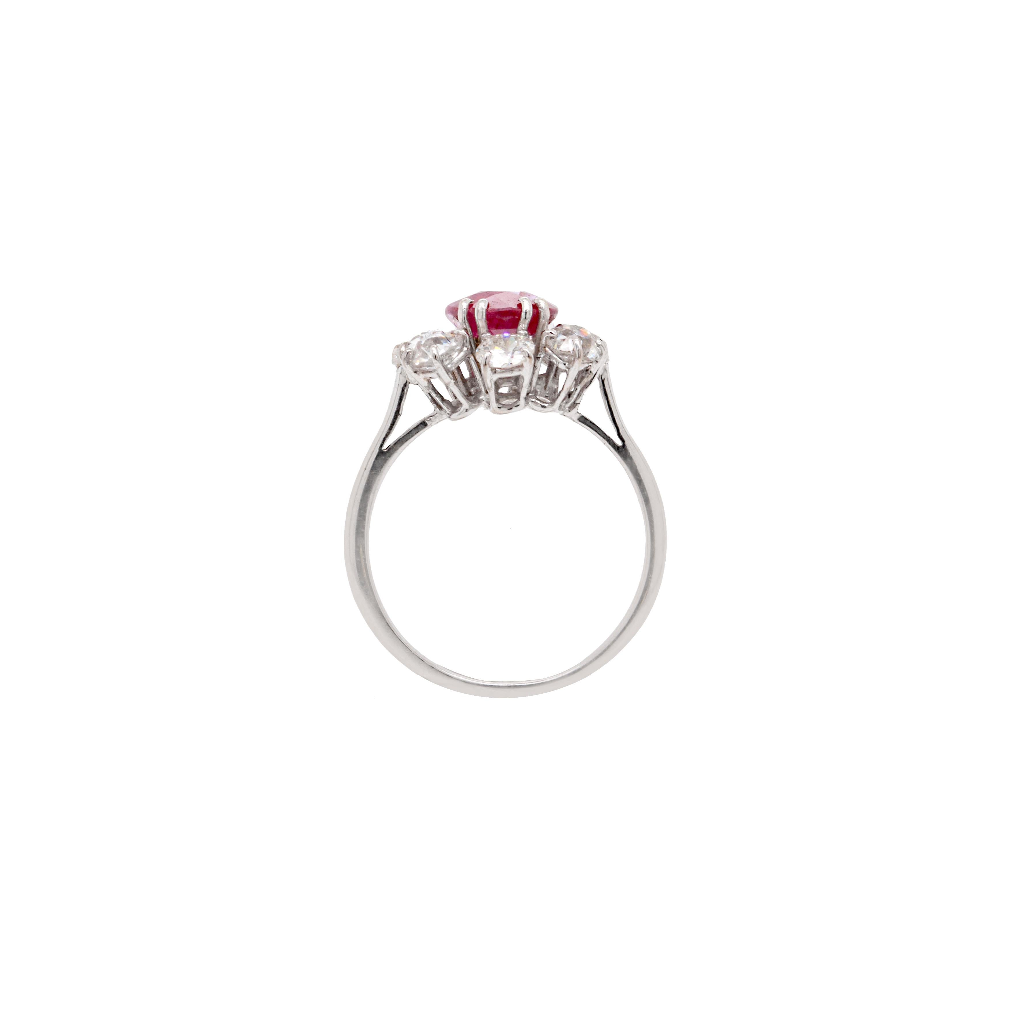 This gorgeous ruby and diamond cluster ring set in 18ct white gold is the dream vintage ruby engagement ring. We date this beautiful piece to the 1960s or 1970s, and it's finished with French hallmarks on the back of the band.

The breathtaking ruby