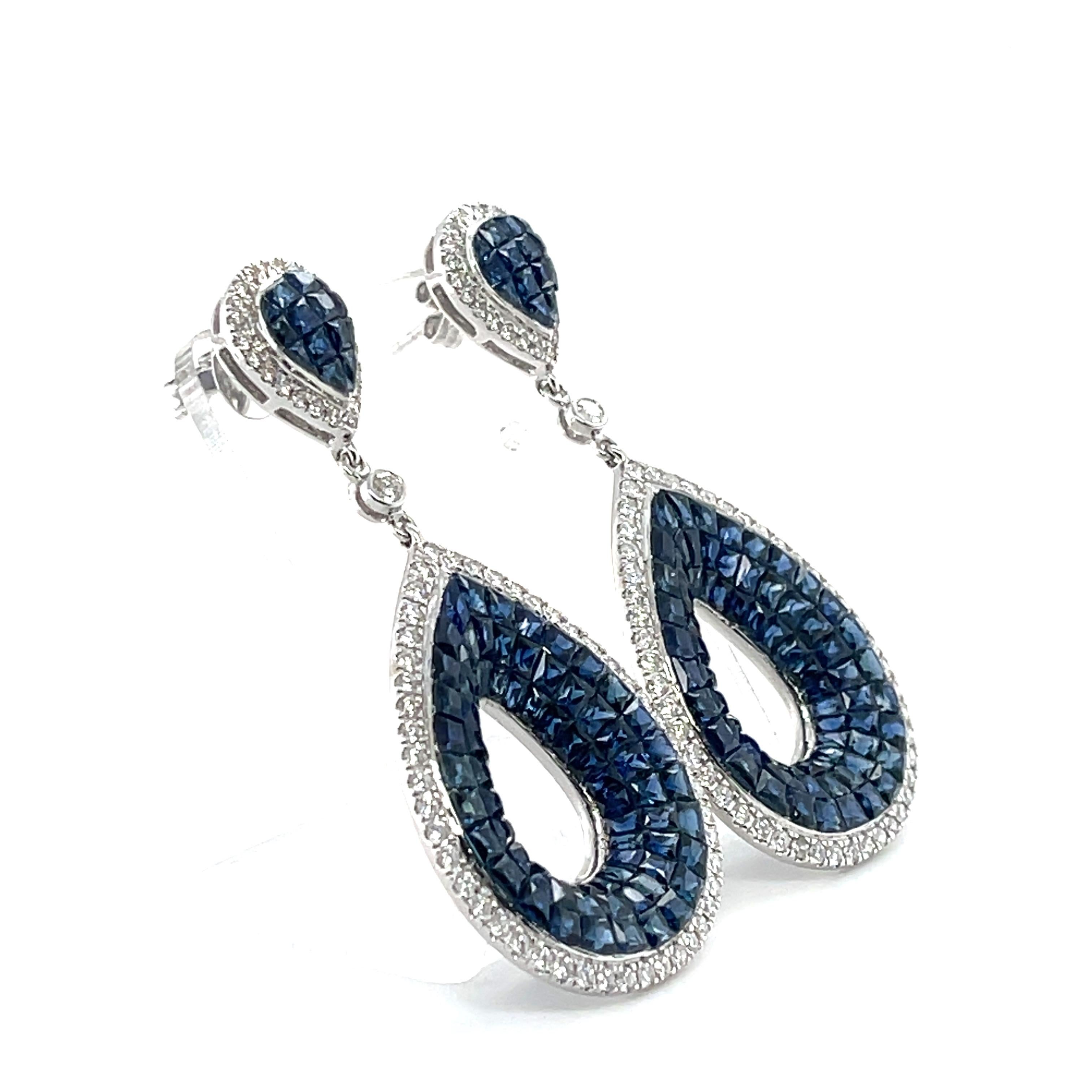 Sapphires and Diamonds, crafted with eighteen karat white gold, featuring a stunning selection of one-hundred and ninety invisible set rectangular cushion natural blue sapphires and one-hundred and forty six claw and bead set round brilliant cut