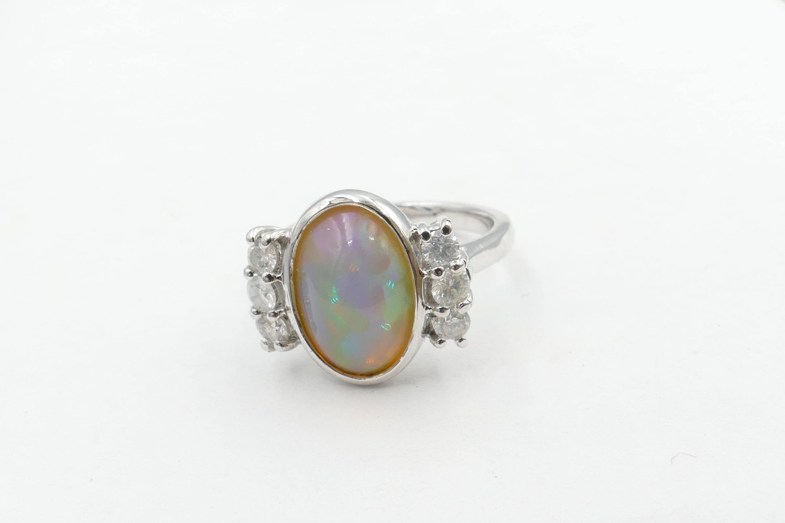 This lovely Solid Opal Ring is made up of an Oval Shape Cabochon Oval set in 18 ct White Gold with 6 Diamonds set to the side.
The Diamonds weigh apporoximately 0.6 carat, Colour G/H and Clarity SI--I1.
Total Item Weight 7.66 Grams
Method of