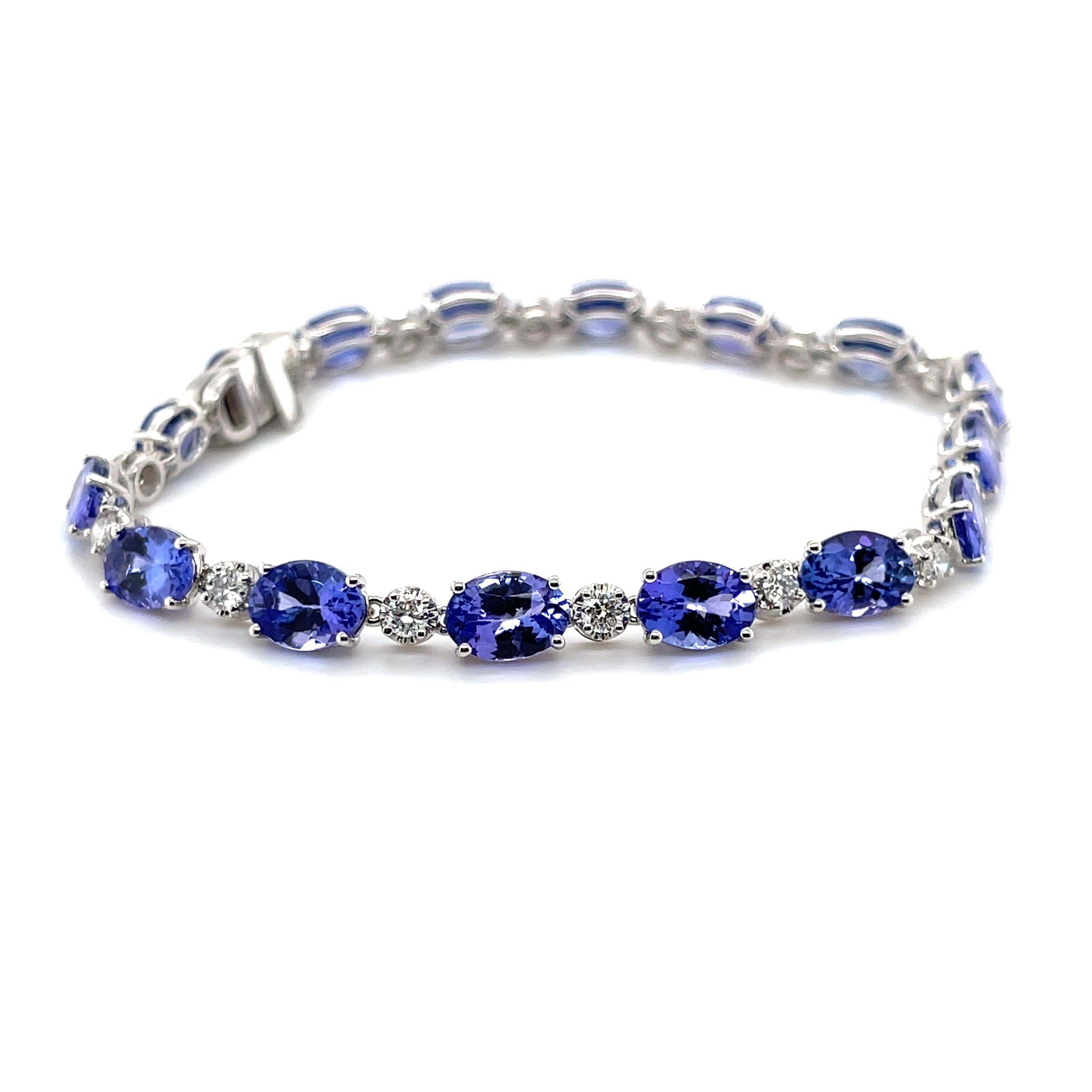 Oval shaped tanzanites, crafted with eighteen karat white gold, featuring sixteen claw set natural round brilliant cut diamonds, also sixteen claw set oval shaped natural tanzanites. complimented with a polished finish design.

Tanzanites weight: