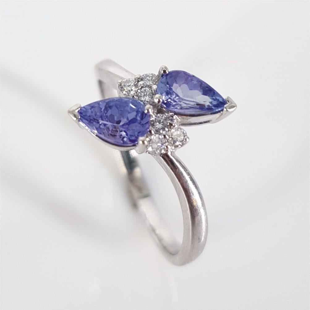 Set in 18carat white gold and weighing 3.3 grams, this ring features 2 Pear Cut Tanzanite’s weighing 0.50carat each, and is surrounded by 6 Round Brilliant Cut Diamonds (GH vs-si) weighing 0.01carat each. The ring size is O ¾ 
