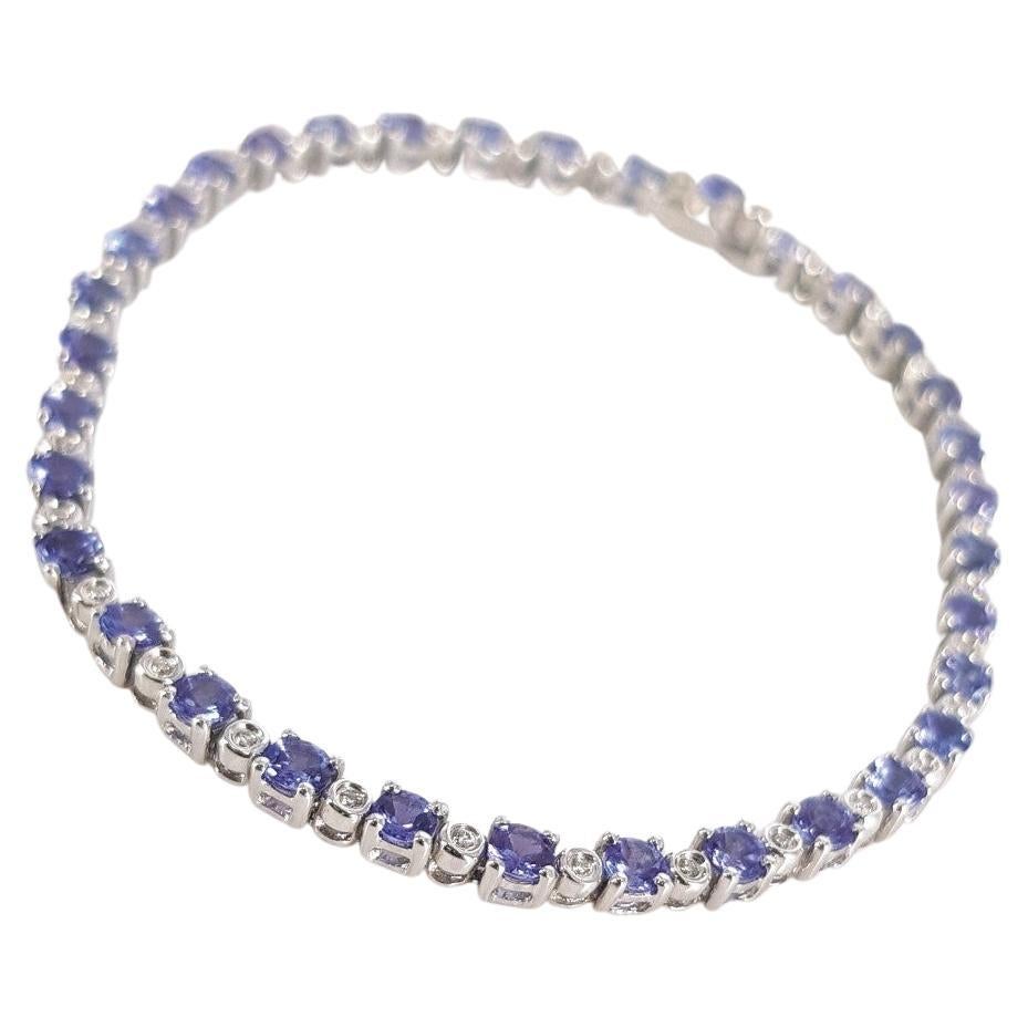 This Beautiful studded Tennis Bracelet is set in 18 carat White Gold, weighs 11.2grams and measures 19cm in length, 2mm wide and 3mm in height. This Bracelet features 34 RBC Tanzanite’s weighing 4.08carat in total and 34 RBC Diamonds (GH vs-si)