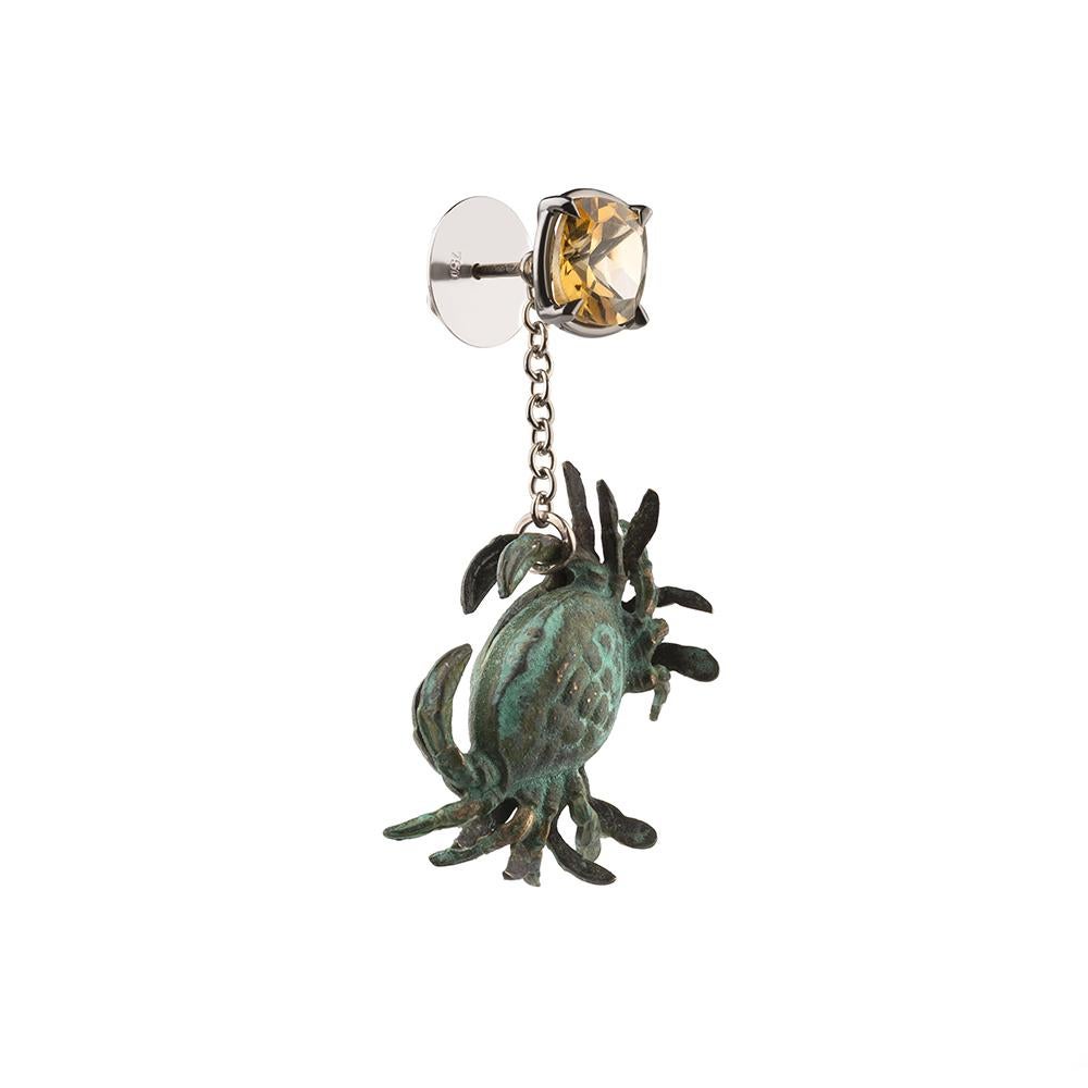 18ct white gold, verdigris brass, black rhodium, white enamel and citrine earrings
One-of-a-kind
Hallmarked

In the north west corner of Tessa’s imagined garden there lives a watery grotto. Its cave-like walls are decorated with broken seashells and