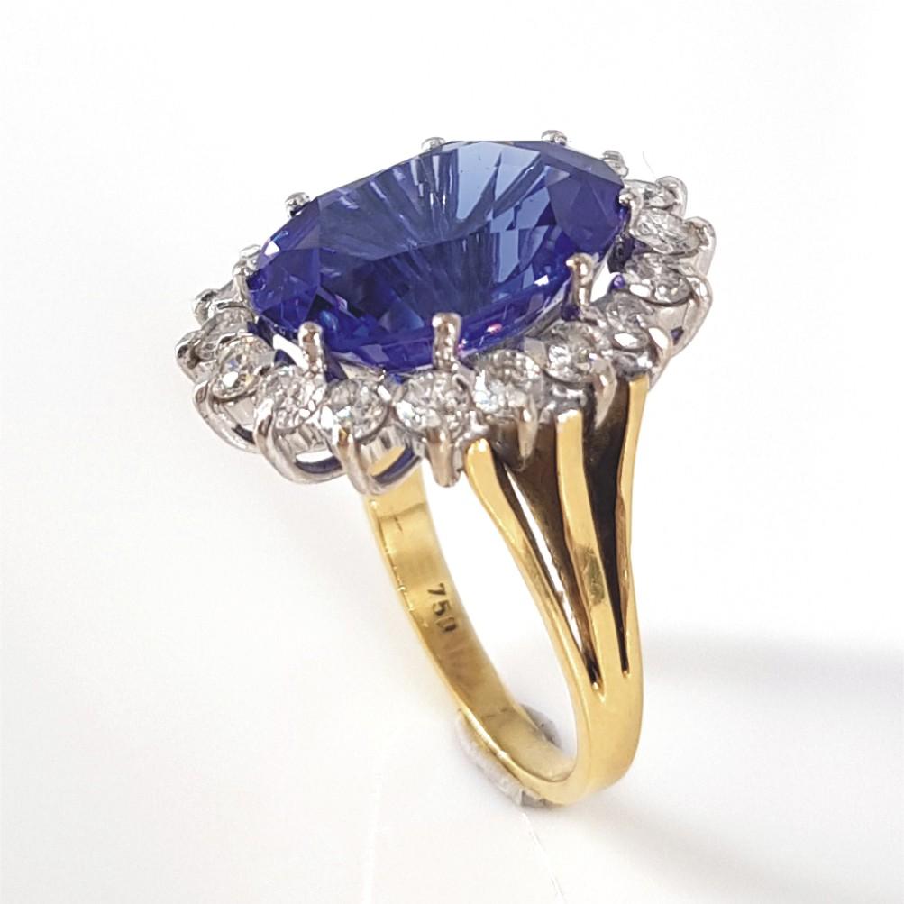 This beautiful piece giving us a Royalty feel is set in 18carat white & yellow gold weighing 8.5 grams.
This Ring features 1 Oval Tanzanite weighing 8.16carat, and is surrounded 18 RBC Diamonds (IJ vssi) weighing 1.16carat in total. The ring size is