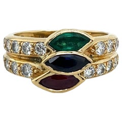Bague en or jaune 18 ct à 3 bandes diamantées, émeraude, saphir, rubis