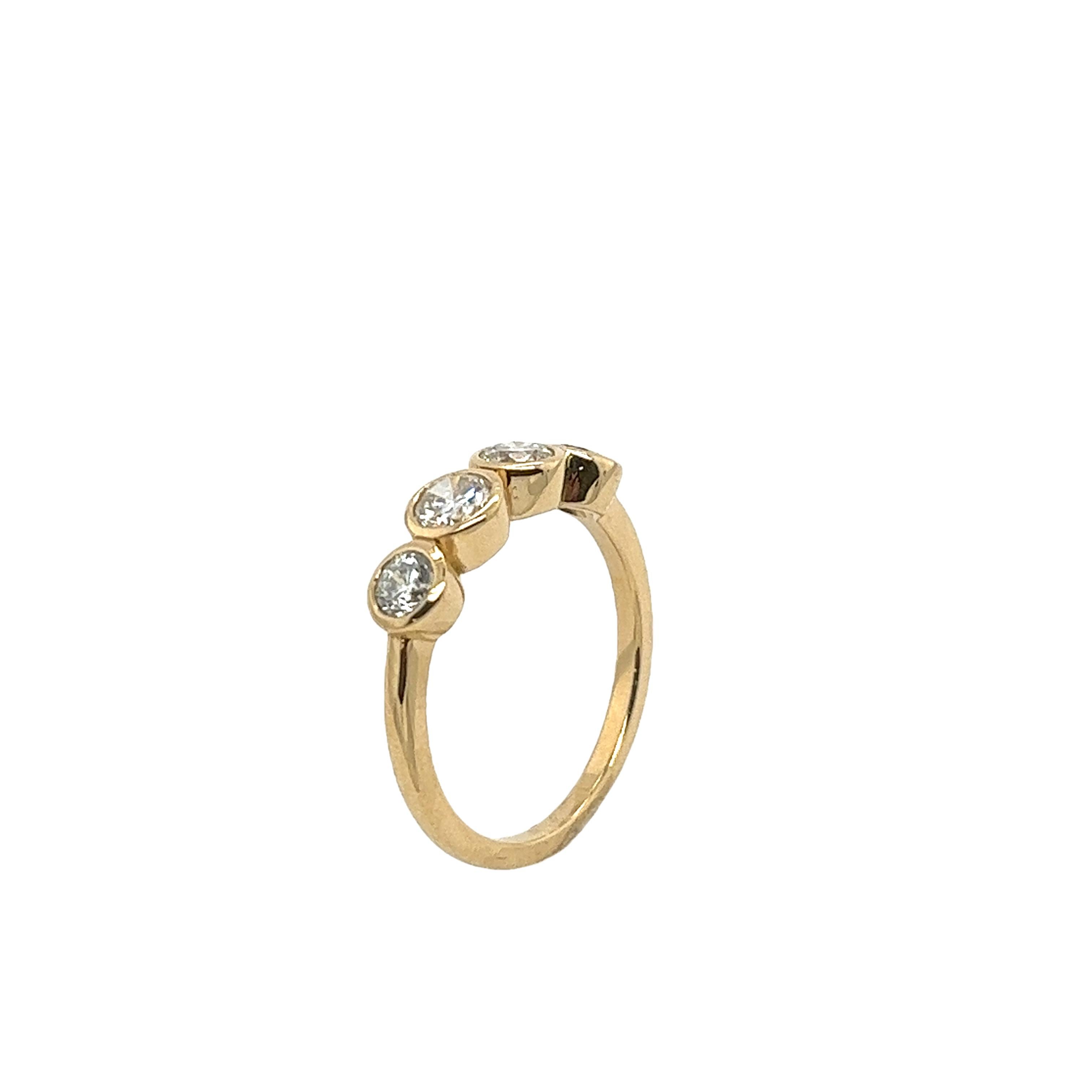 An elegant 4 stone diamond ring, 
set with 4 round brilliant cut natural diamonds, 
0.94ct total diamond weight.
in an 18ct yellow-gold bezel setting.
Total Diamond Weight: 0.94ct
Diamond Colour: G/H
Diamond Clarity: SI1
Width of Band: 1.67mm
Width