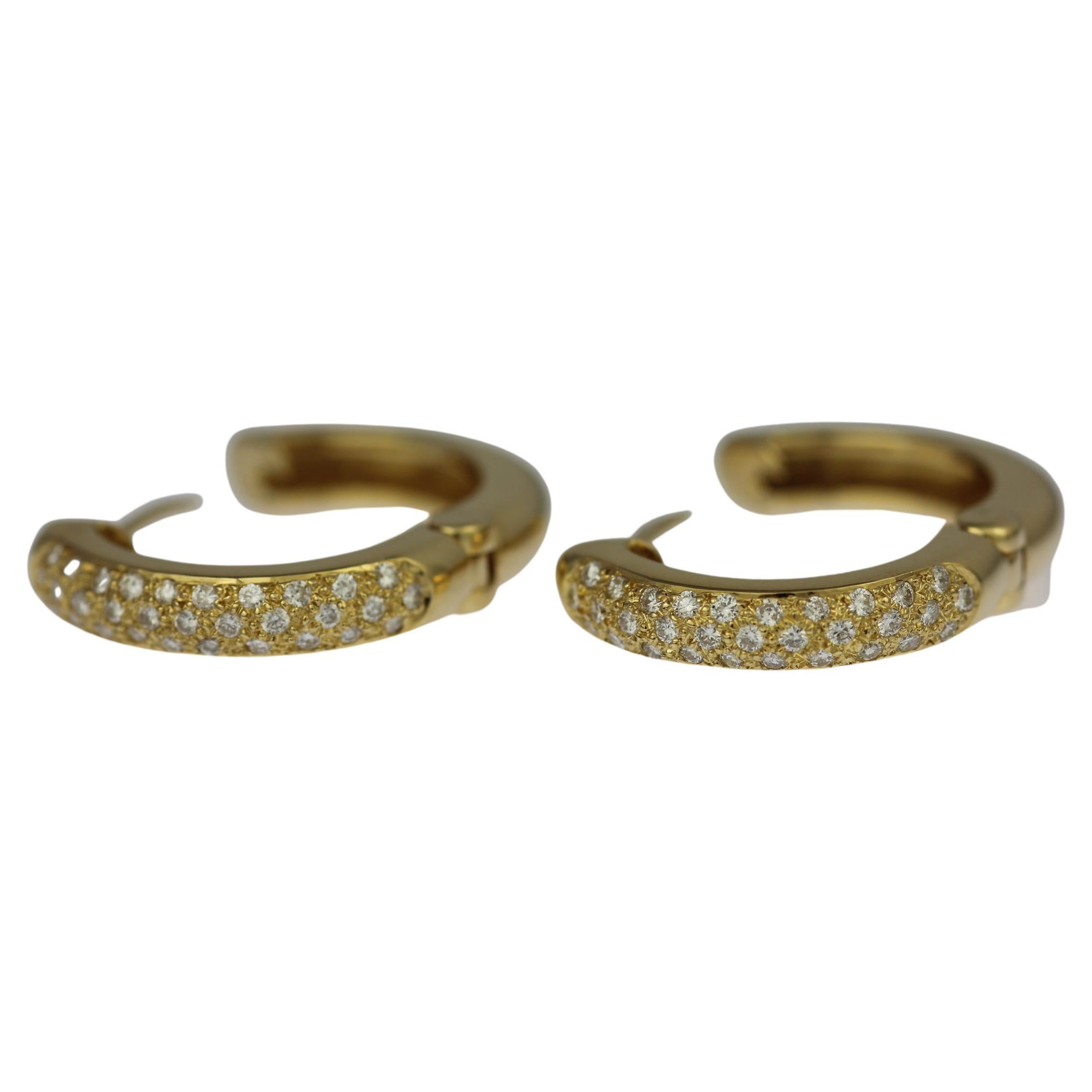Polished 18ct yellow gold hinged hoop earrings with huggy style closure.

Featuring pave diamond fronts set with a total of 64 round brilliant diamonds weighing 0.32ct.

The rear side of the hoops are smooth polished gold.

Hoop height: 26mm
Hoop