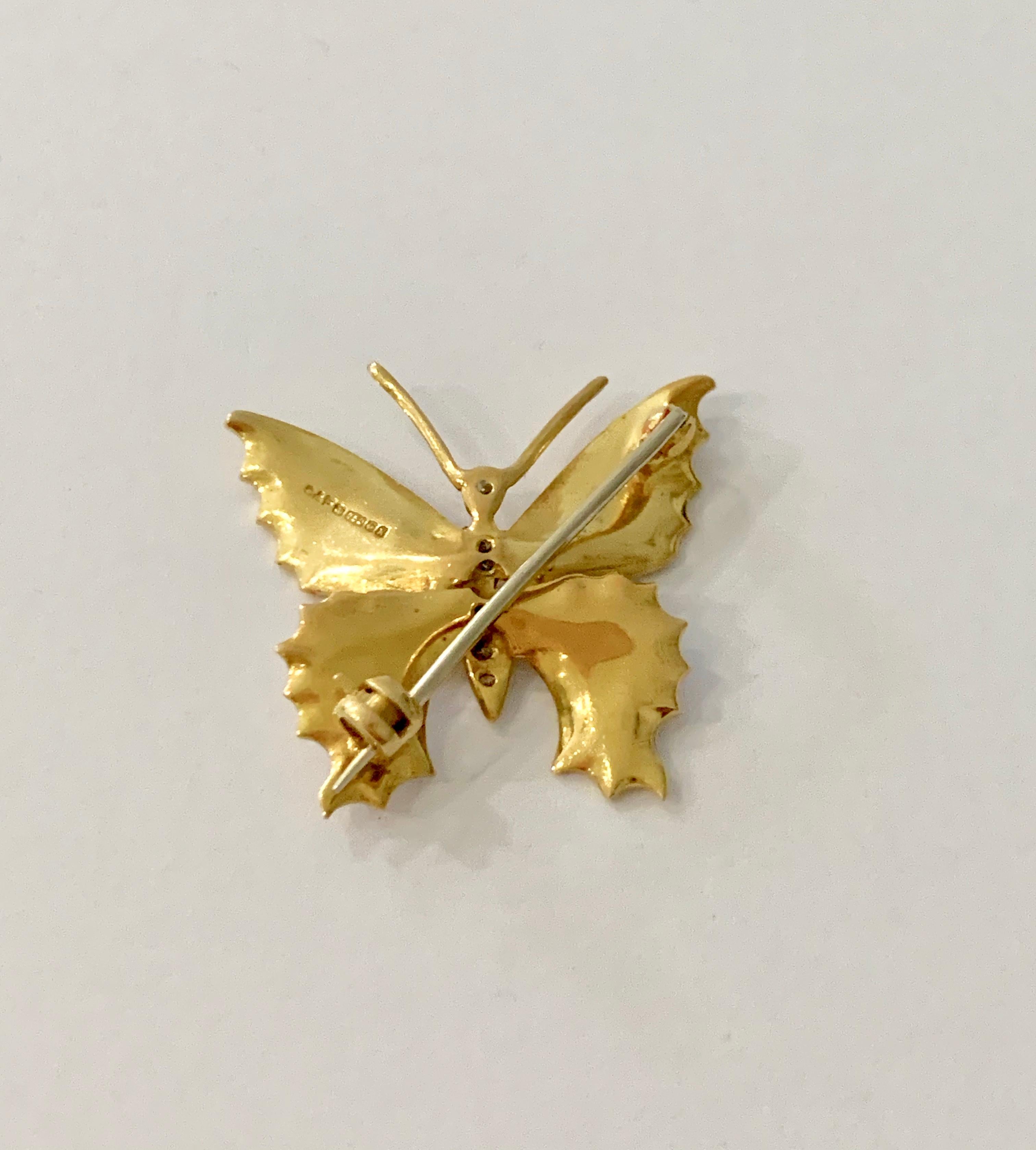 This is such a pretty and delicate gold and white enamel brooch, it would look elegant worn by anyone of any age.   The brooch is made of 18ct Yellow Gold and has off white enamel set on all four wings.  The body of the butterfly is set with 6 round