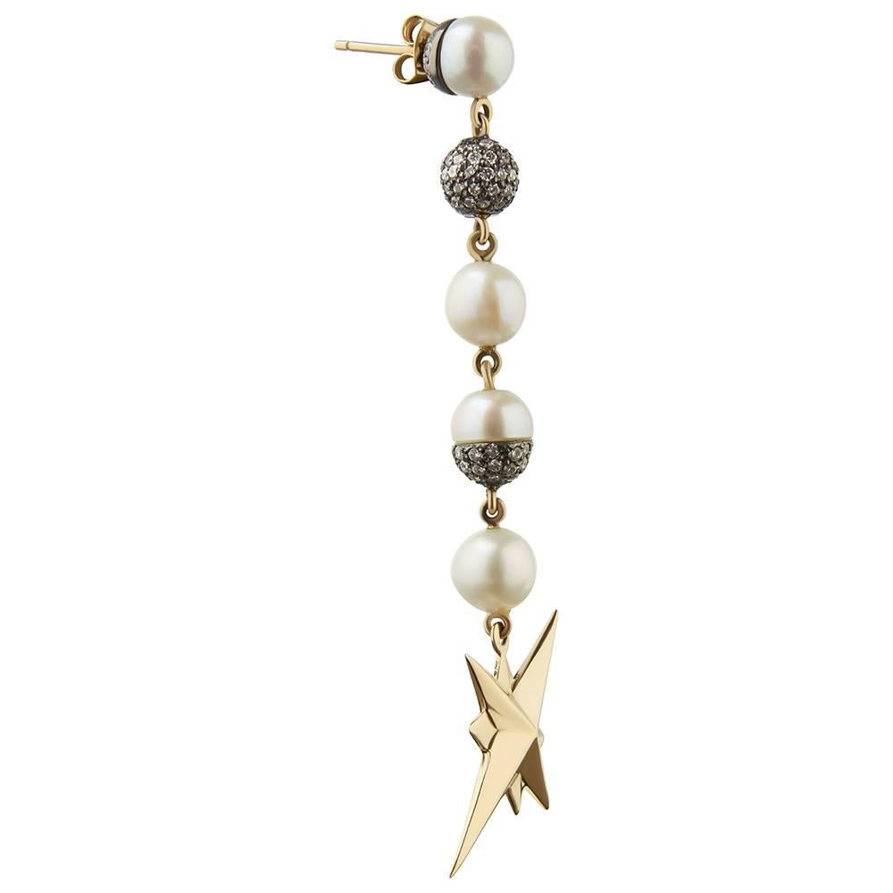 18ct yellow gold, blackened silver, cultured freshwater white pearl and diamond earrings
One-of-a-kind
Hallmarked

Tessa is frequently recognised for her narrative-rich, irreverent jewellery that vividly bring to life the themes behind her dynamic