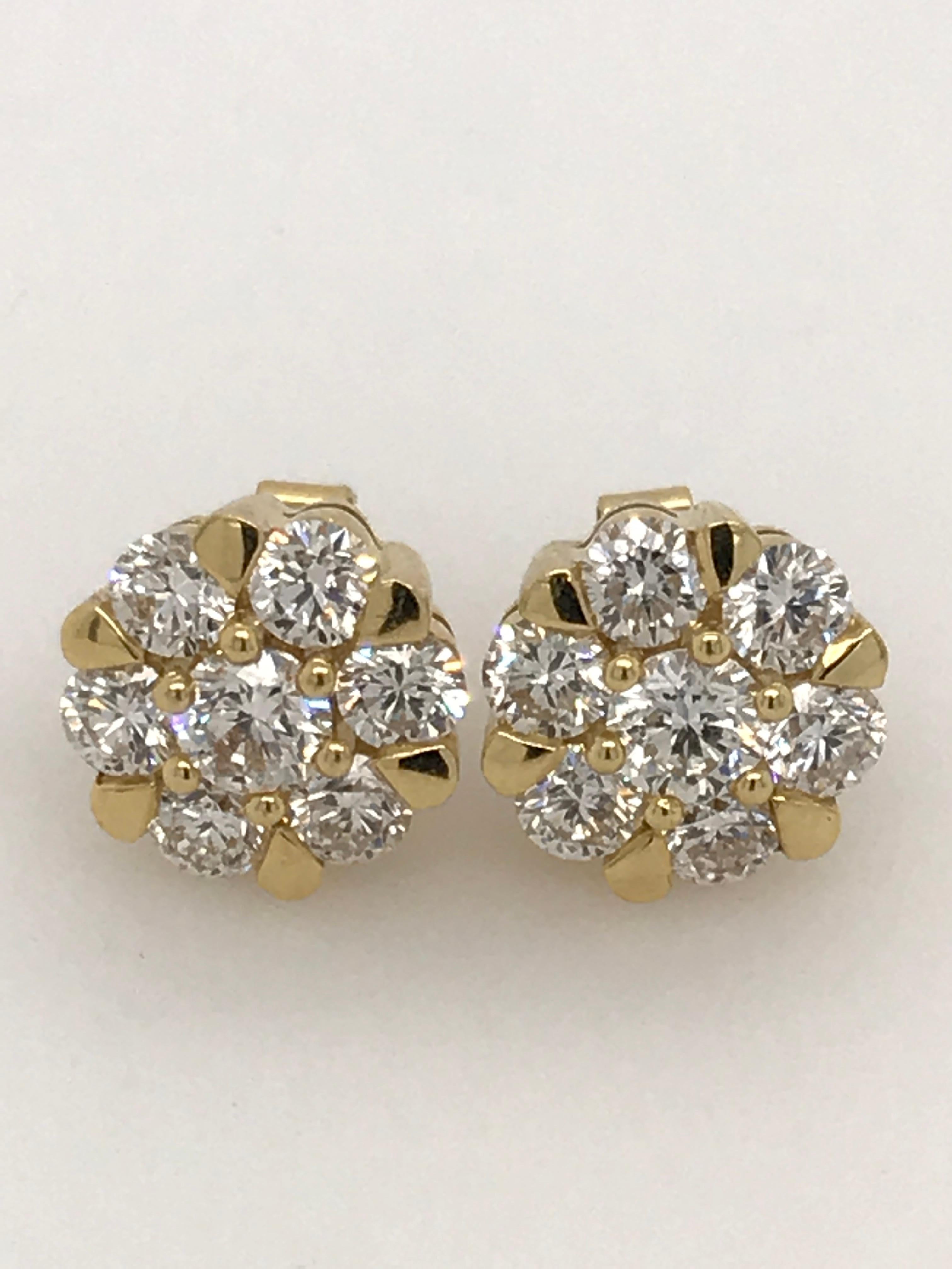 Diamond earrings with 2.09ct HSI brilliant cut diamonds set in 18ct yellow gold. The earrings are post and butterfly. The post extends from the back centre and they measure approximately 11mm across.
14 brilliant cut diamonds totalling 2.09ct
There