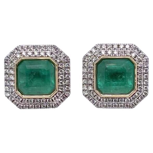 Pair of rub over set emerald cut Colombian (Based on my opinion) emeralds, crafted with eighteen karat yellow gold, featuring a stunning collection of one hundred and twenty-eight claw set round brilliant cut diamonds. complimented with a polished