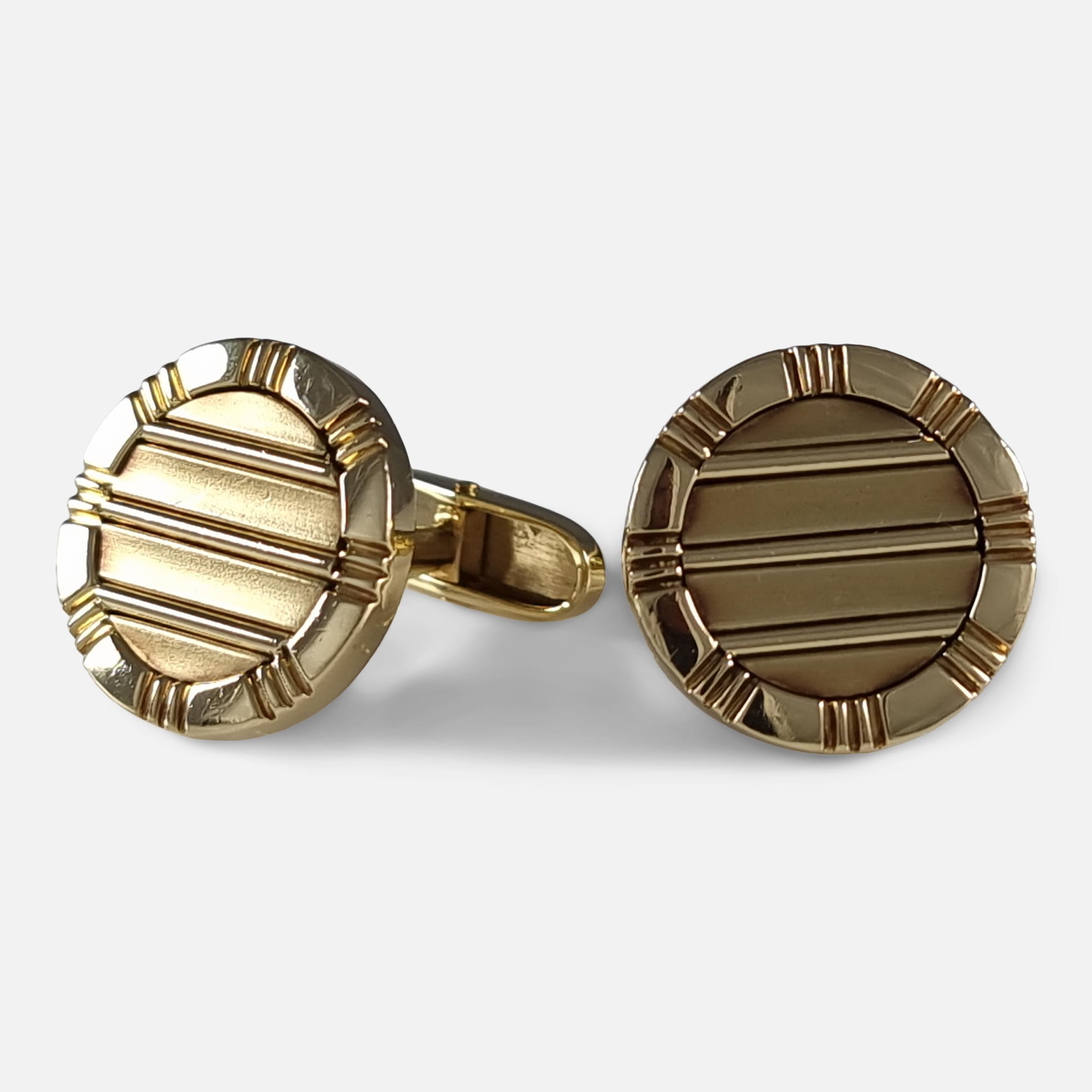 A set of 18ct yellow gold circular cufflinks by Asprey. The cufflinks are single-sided, with a circular reeded plaque design, and signed Asprey.

The cufflinks are hallmarked with the makers mark 'APLC', London import marks, 1994, and '750' to