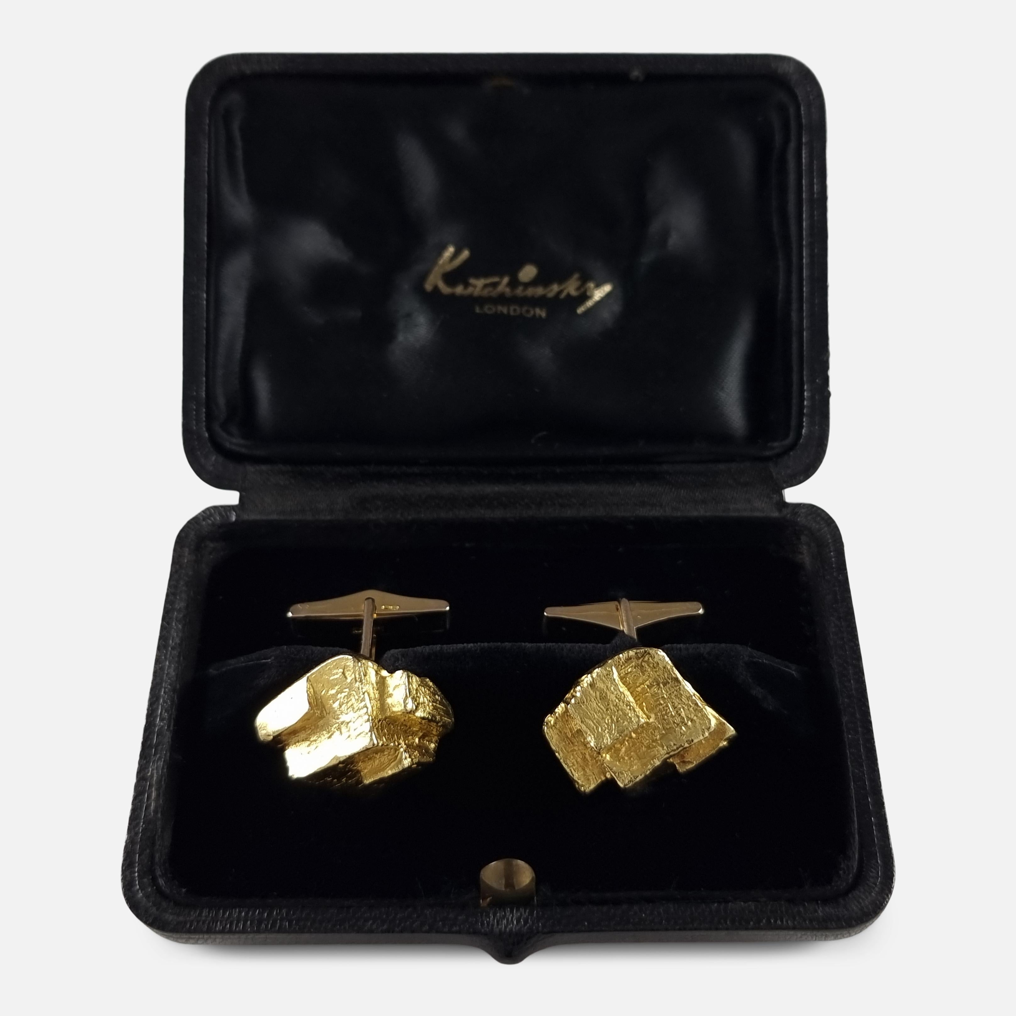 A set of 18ct yellow gold cufflinks by Kutchinsky. The cufflinks are single-sided, with a textured cuboid form, and signed Kutchinsky.

The cufflinks are hallmarked with the makers mark 'KLD', London hallmarks, and '18' to denote 18 carat gold.

The