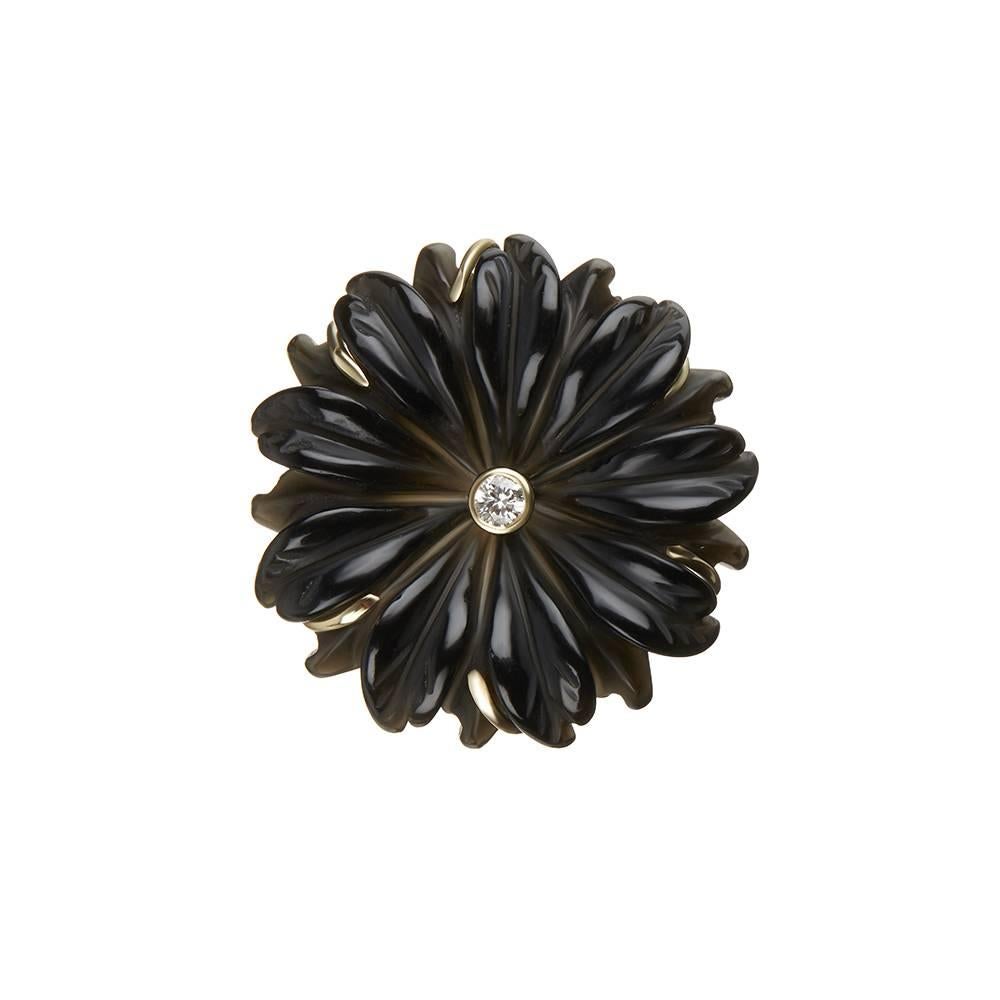18ct yellow gold, diamond and hand-carved onyx ring
Edition 1/2
Hallmarked
UK Size N/O

Inspired by the daisy, this beautifully hand-crafted ring is the perfect every-day accessory. Its neutral, elegant colours allow it to be easily paired with any