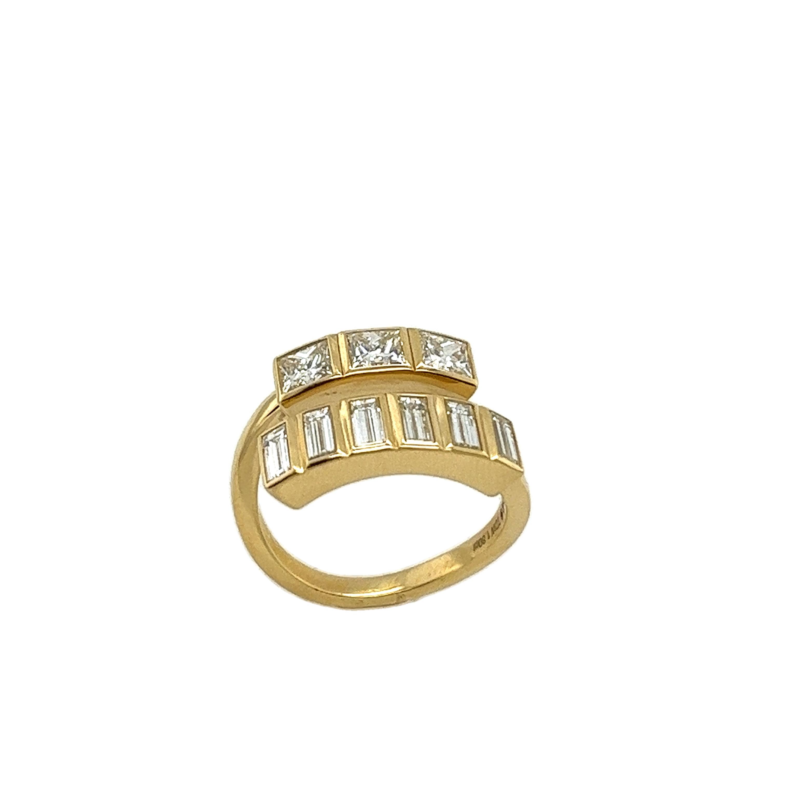 An elegant 9 stone diamond ring, set with 3 princess cut natural diamonds
& 6 baguettes diamonds, with total diamond weight 1.80ct. in an 18ct yellow-gold bezel setting.

Total Diamond Weight: 1.80ct
Diamond Colour: G/H
Diamond Clarity: SI1
Width of
