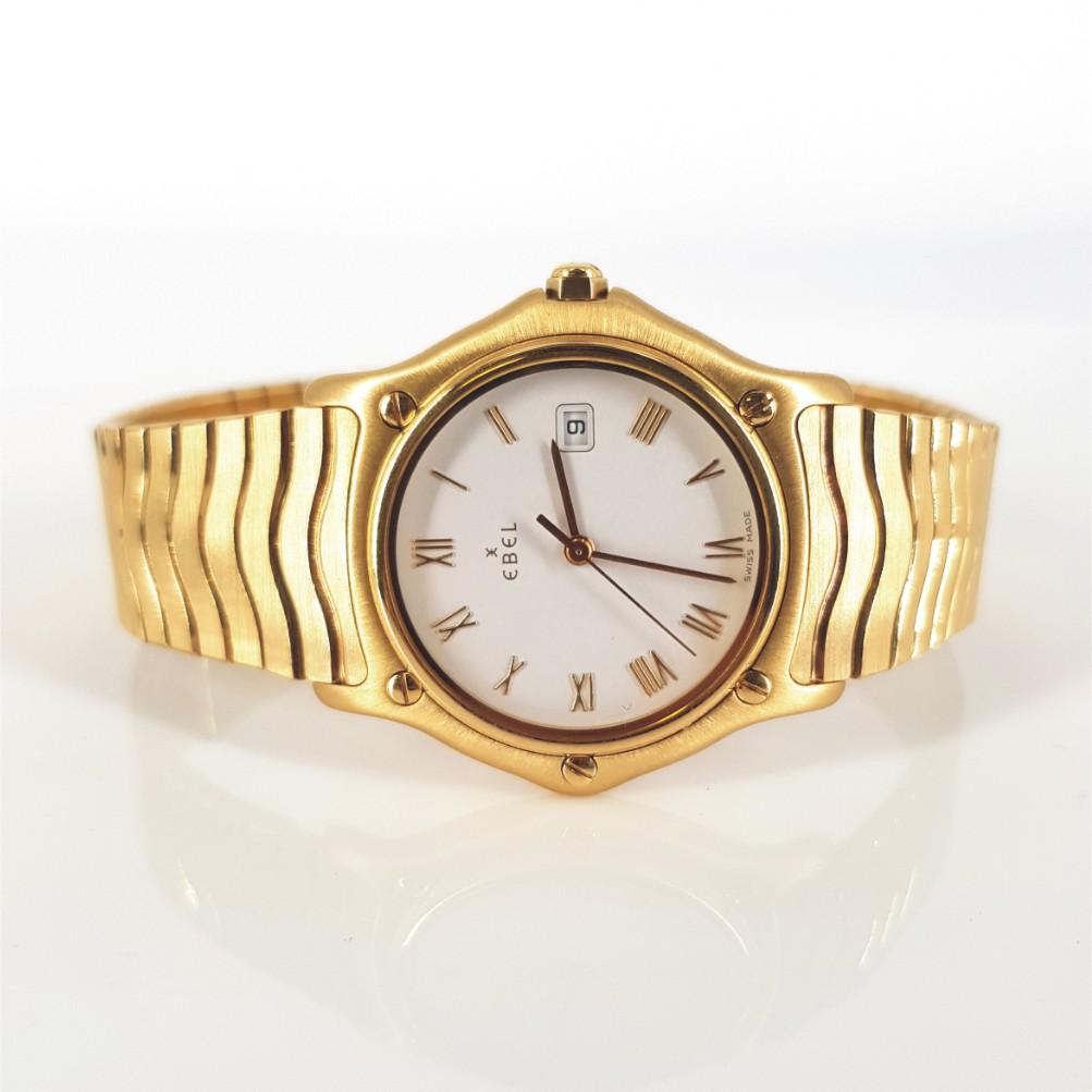 18ct Yellow Gold Ebel Watch – In Excellent condition.
Model Number: 00120 & Serial Number: E8087131. 
18ct yellow gold case (31mm diameter). White dial with gold hands. Integrated 18ct Yellow Gold mesh style bracelet (53mm)
