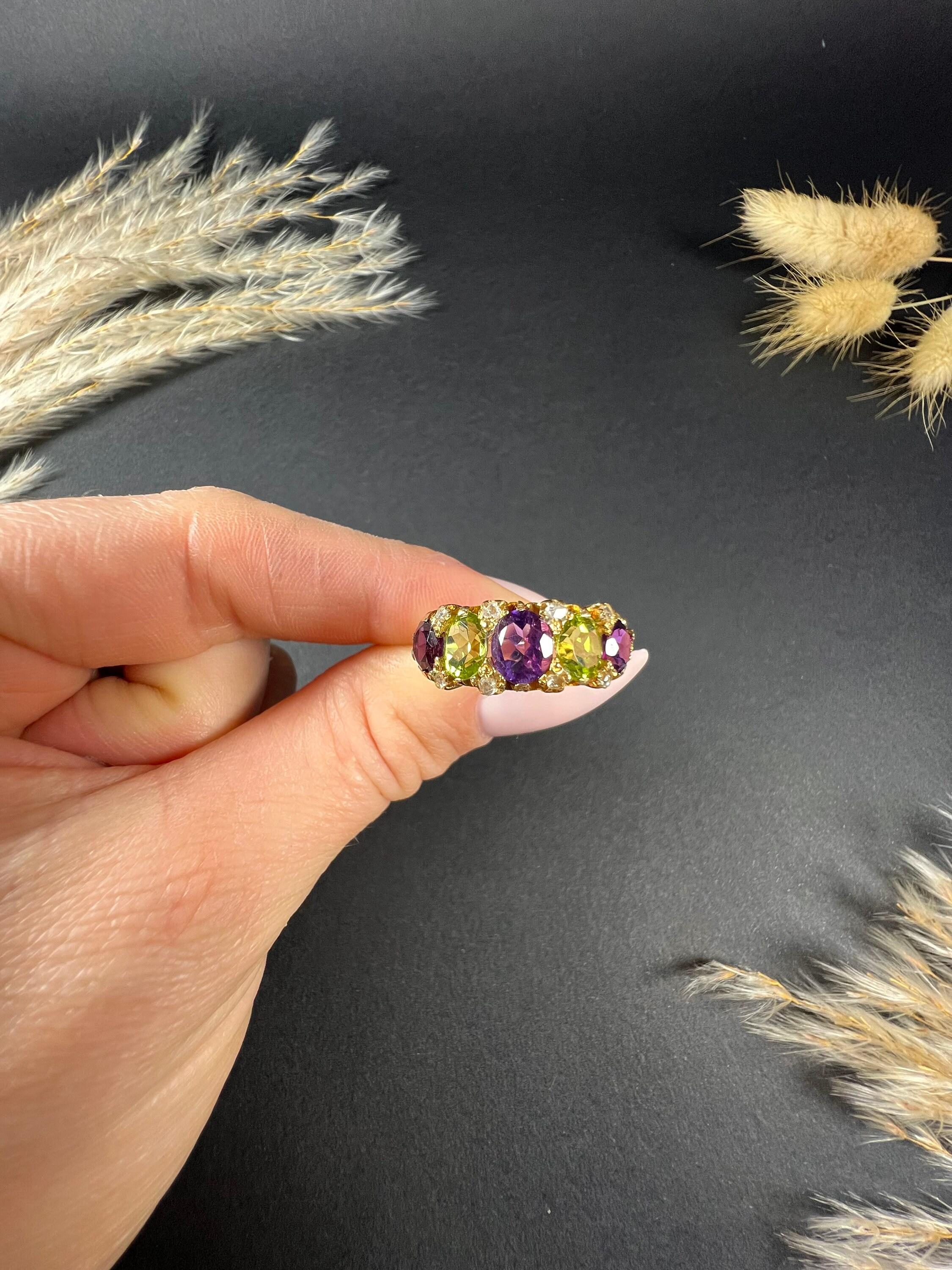Antique Suffragette Ring 

18ct Gold Tested

This beautiful Edwardian suffragette ring is a true testament to the elegance and style of the era. Made from 18ct yellow gold, it features exquisite amethysts, peridots, and rose-cut diamonds that