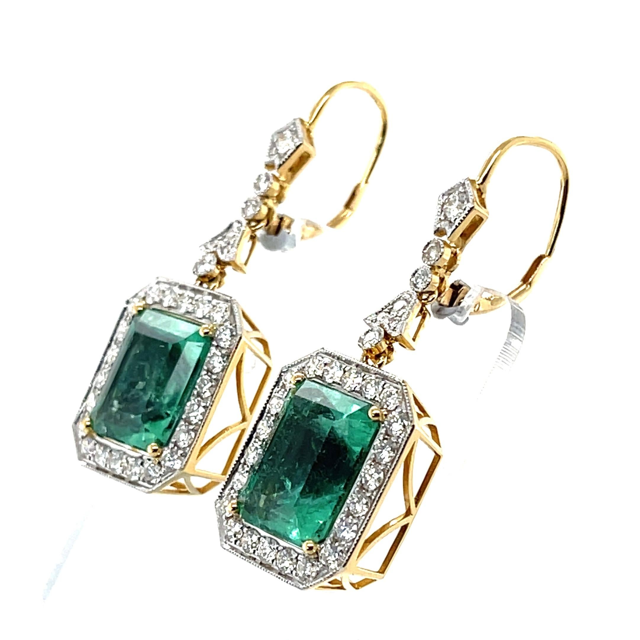 Pair of emerald cut Colombian (based on my opinion) emeralds, crafted in eighteen karat yellow gold, featuring a stunning collection of fifty-eight claw and rub over set round brilliant cut diamonds. complimented with a polished finish