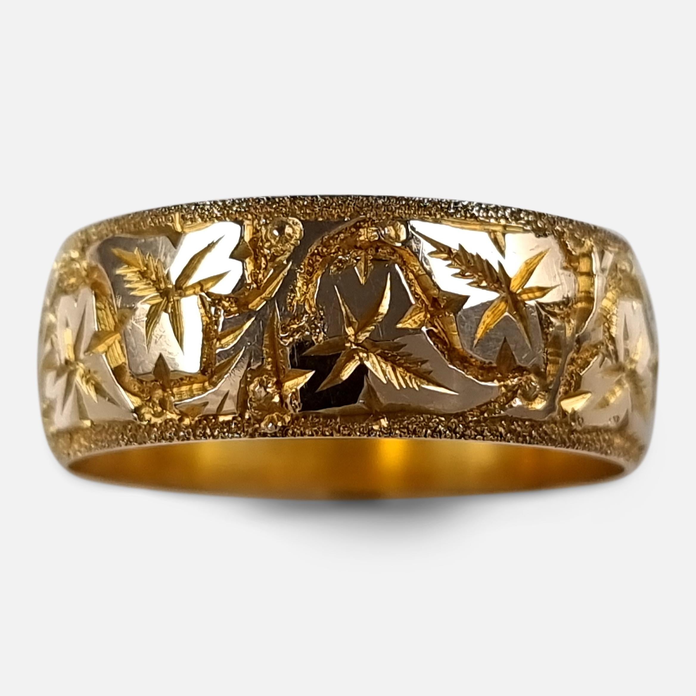 A George V 18ct yellow gold foliate engraved Keeper ring.

The ring is hallmarked with Birmingham marks, '18' for 18 carat gold, and date letter 'V' to denote 1920.

Assay: - .750 Gold (18ct).

Date: - 1920.

Period: - Early 20th