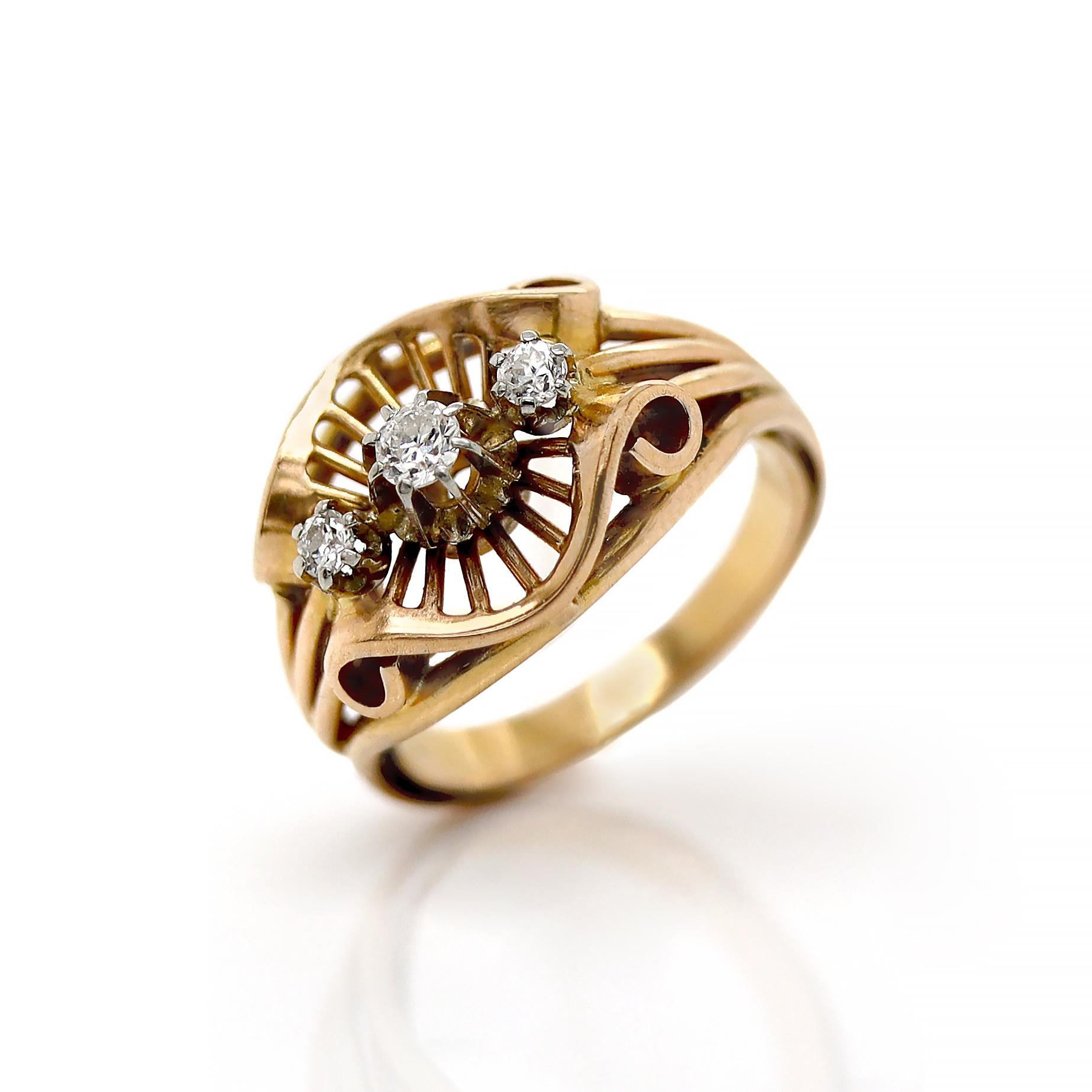 French 18ct Yellow Gold Diamond Retro Ring

This exquisite gold retro ring is a true testament to vintage craftsmanship and timeless elegance. The focal point of the design features three stunning old European cut diamonds, each showcasing a unique