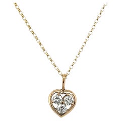 Colgante en forma de corazón de oro amarillo de 18 ct engastado con 3 diamantes redondos