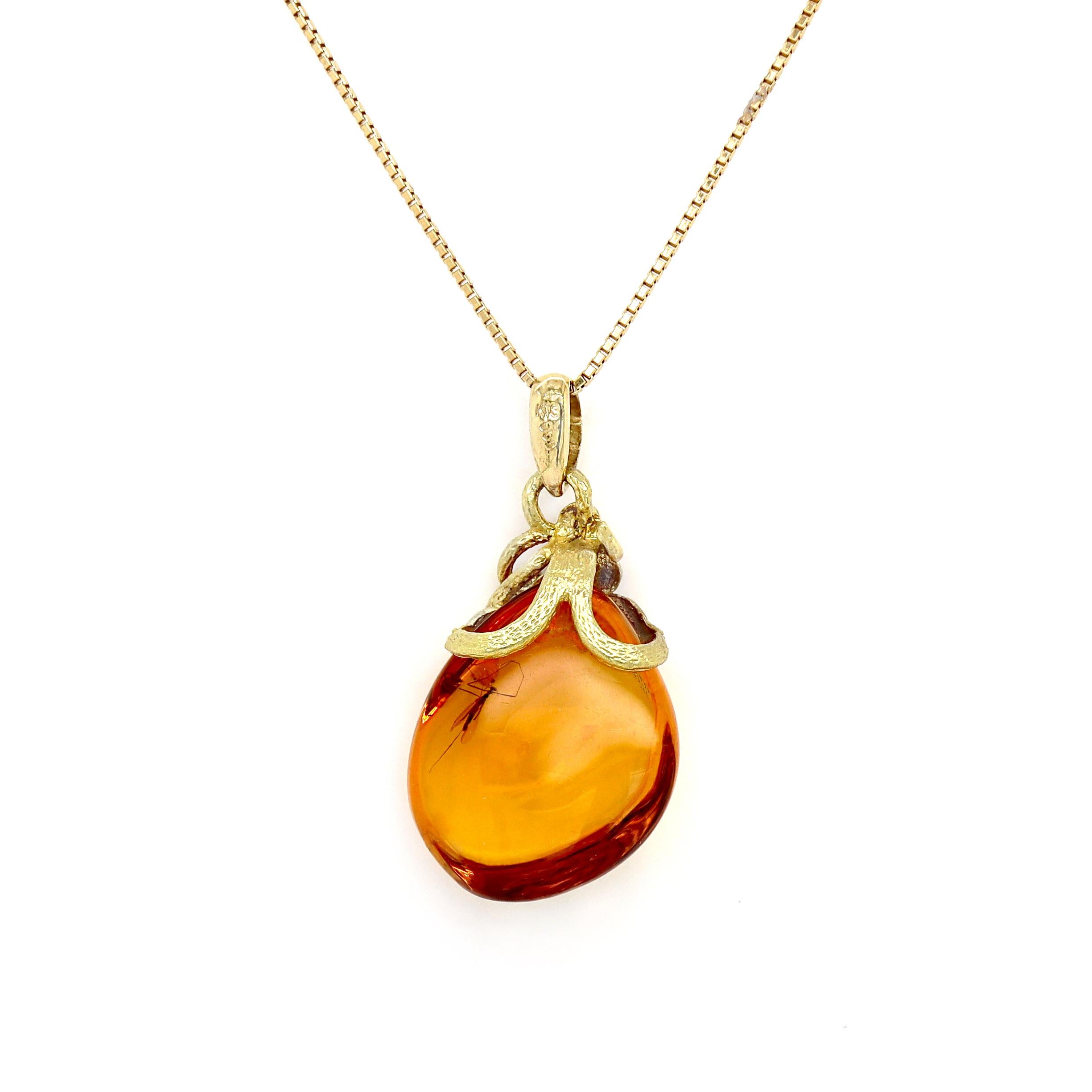 18CT Yellow Gold Insect in Amber and Diamond Pendant with Necklace

This unique pendant features an exquisite insect encased in Amber with a golden hue, creating a captivating natural piece of jewelry, while showcasing the beauty of nature frozen in