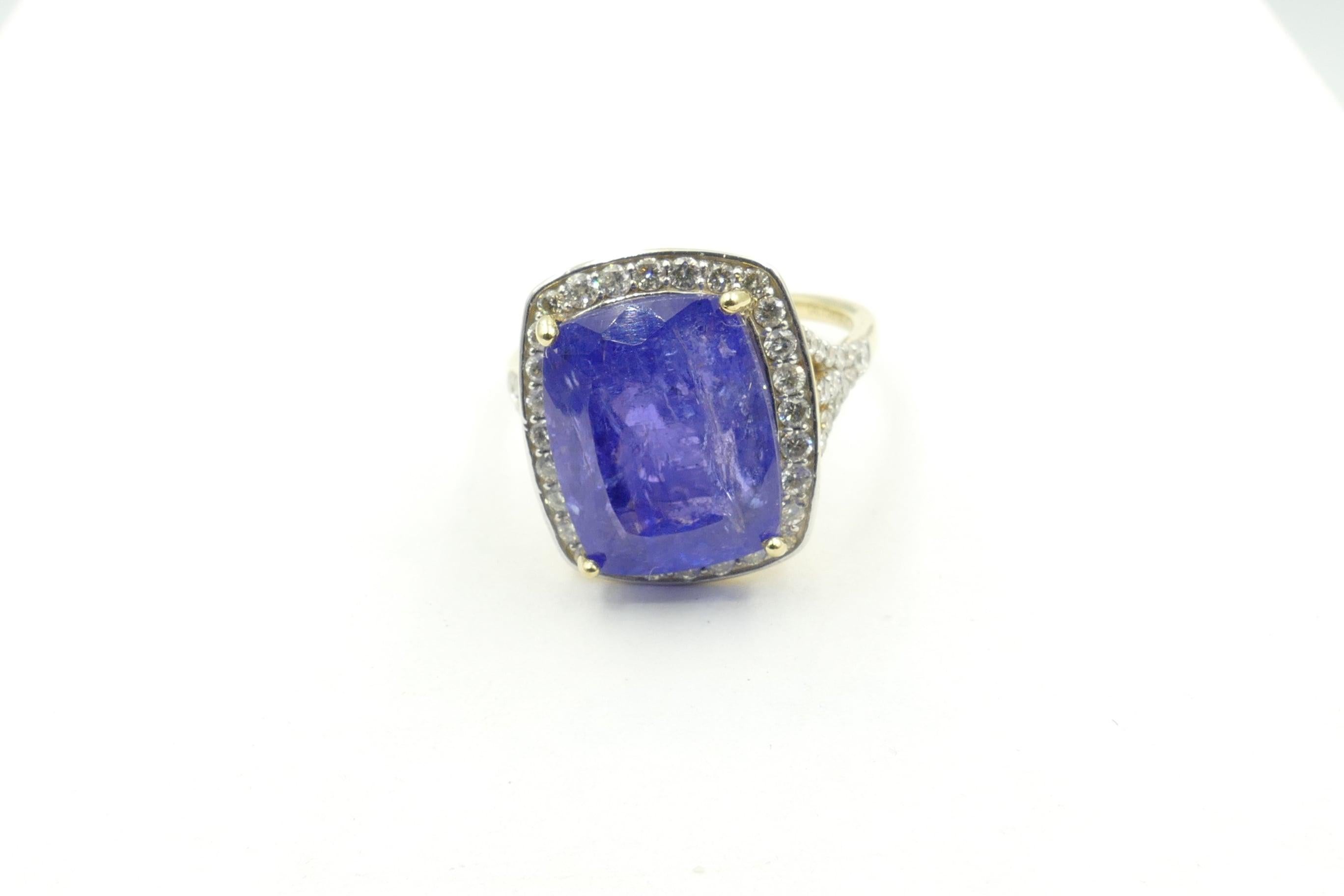 The Centrepiece of this stunning Ring is an approximately 7.5 carat Natural Cushion Cut Tanzanite of medium dark blue Colour with Dimensions 13.44mm length, 11.1mm in width & 7.9mm depth.
It is surrounded by 65 claw set Round Brilliant Cut Diamonds,